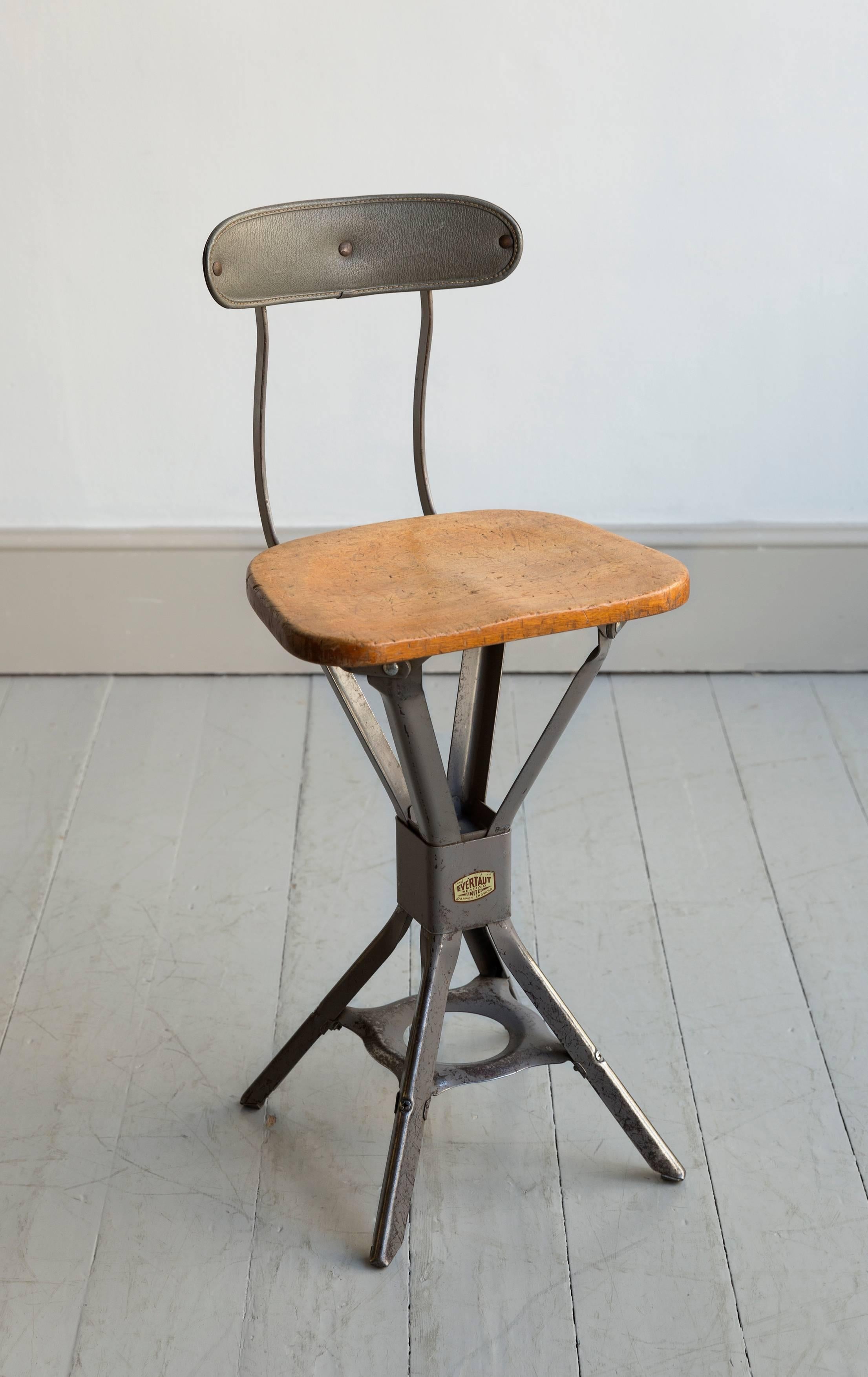 Three industrial ergonomically designed machinist’s chairs by Evertaut, the wood seats supported on a grey metal frame with the original vinyl back rest, English, circa 1950s. Only Three available. 