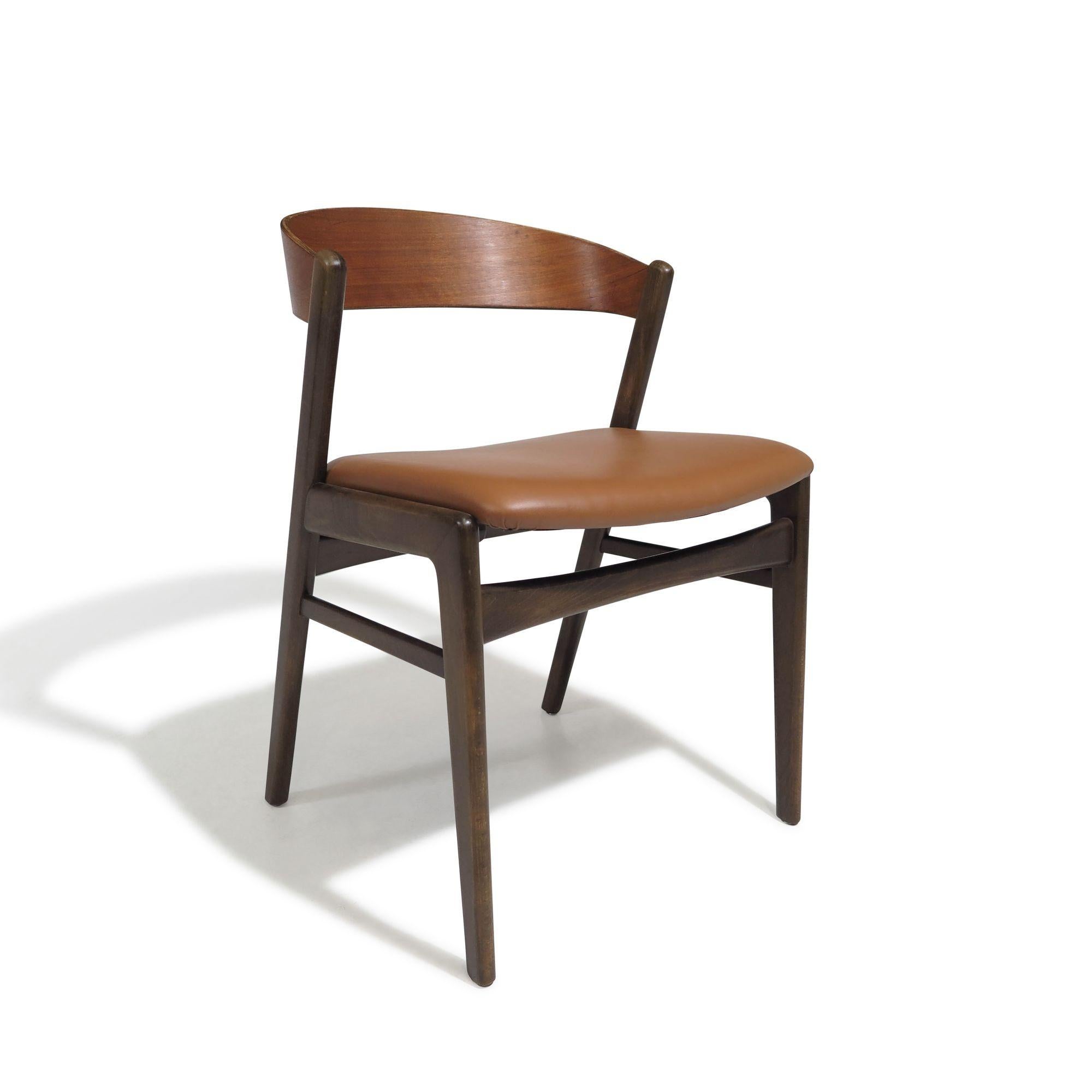 Set of eight mid-century Danish dining chairs designed by Folke Ohlsson (1919-2002) for Dux, 1965, Denmark. The chairs are crafted with dramatic walnut curved backrests and walnut stained beech frames. Newly upholstered seats in saddle
