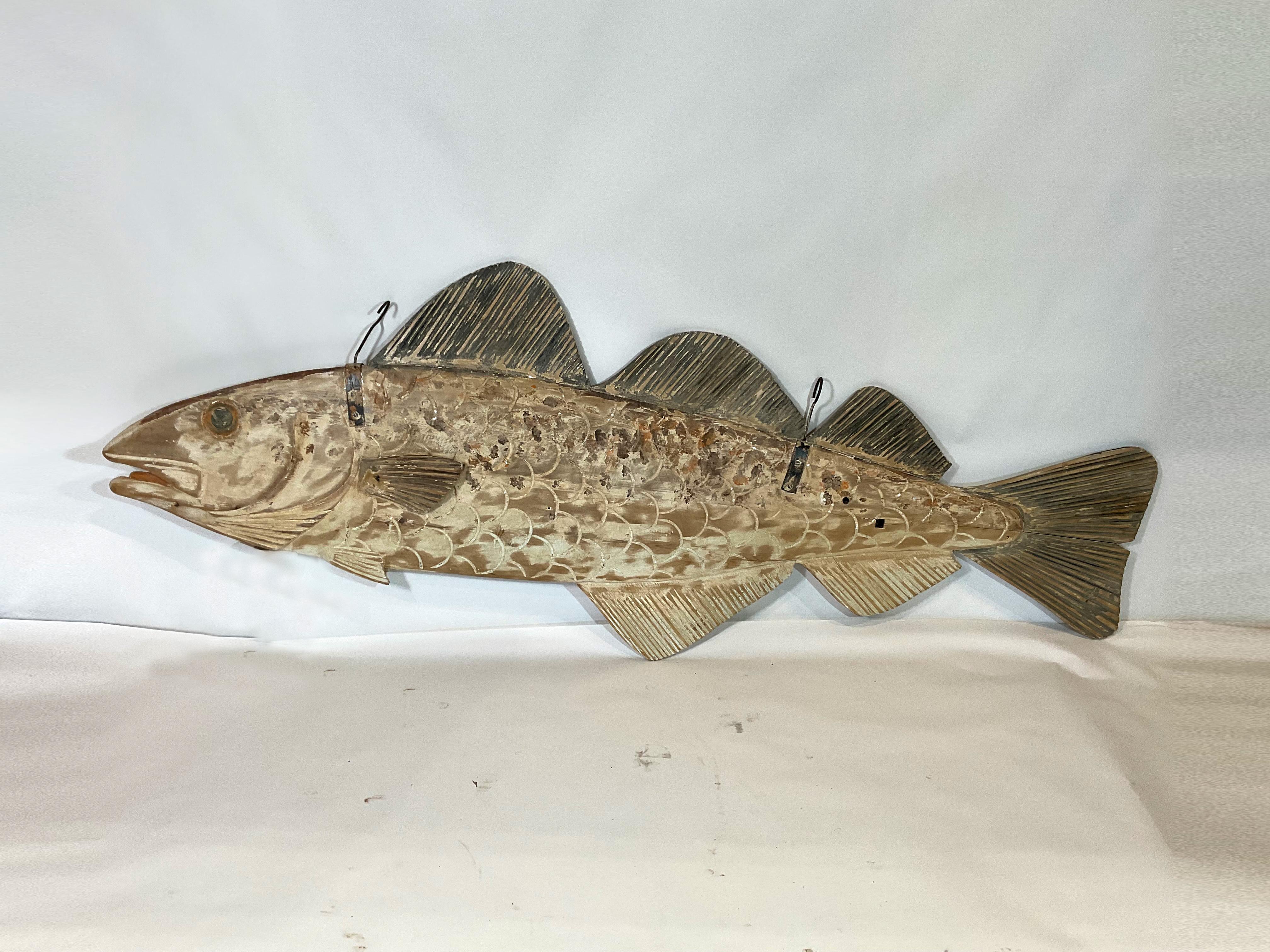 Eight-foot two-sided hanging fish with carved gills, fins, snout, eyes, scales, etc. Fitted with two hooks from England. In the style of trade signs that hung over the stalls in the Dover England Seafood docks. Missing a fin on one side.

Weight: