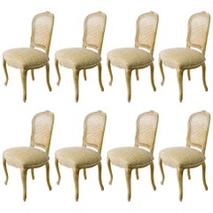Eight French Caned Back Carved Dining Chairs from the 1930s