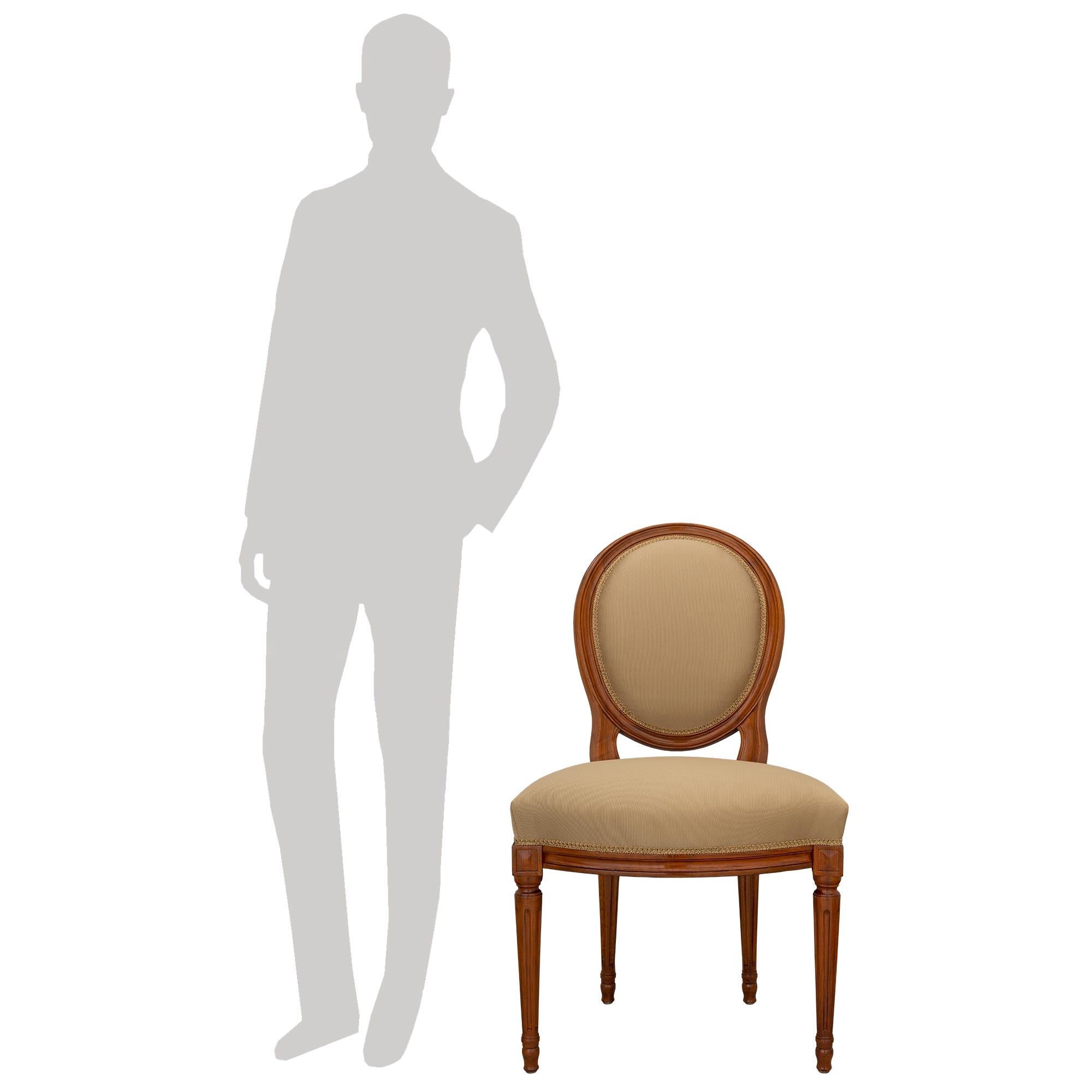 A most elegant and high quality set of eight French turn of the century Louis XVI st. Walnut dining chairs. Each chair is raised by fine circular fluted tapered legs with lovely topie shaped feet. Above each leg are carved block reserves flanking
