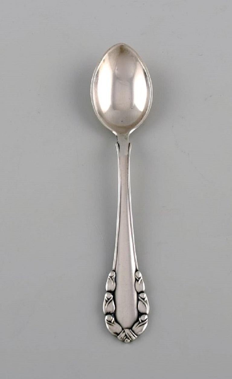 Eight Georg Jensen Lily of the Valley coffee spoons in sterling silver. 
Dated 1933-1944.
Measures: length: 10.6 cm.
In excellent condition.
Stamped.
Our skilled Georg Jensen silversmith / goldsmith can polish all silver and gold so that it