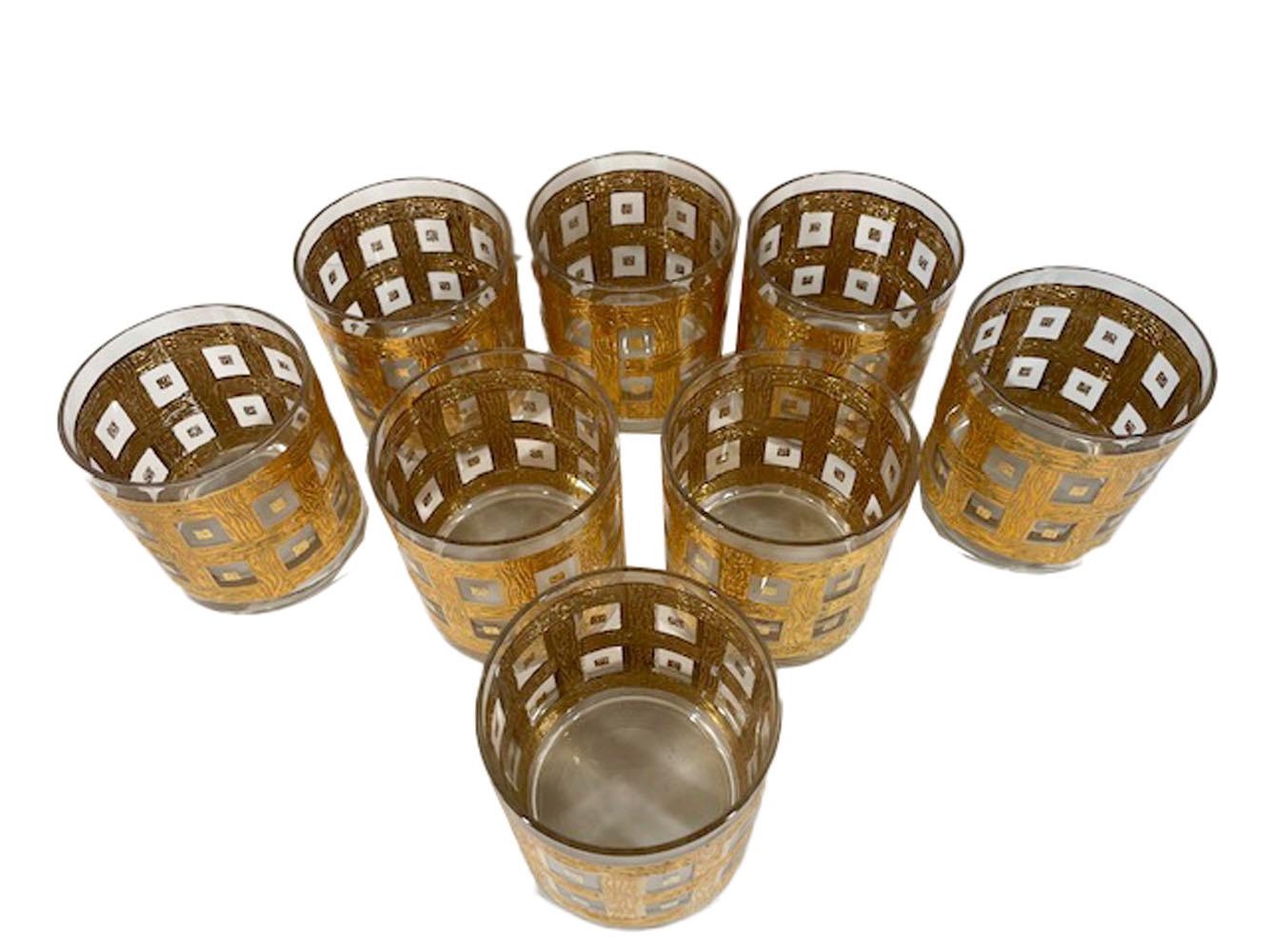 Eight Georges Briard rocks glasses with raised 22 karat gold decoration of woven wood-grained lattice forming a double row of square openings, each with a central gold square.