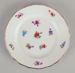 Eight German lunch plates in porcelain. Hand-painted with floral motifs.
