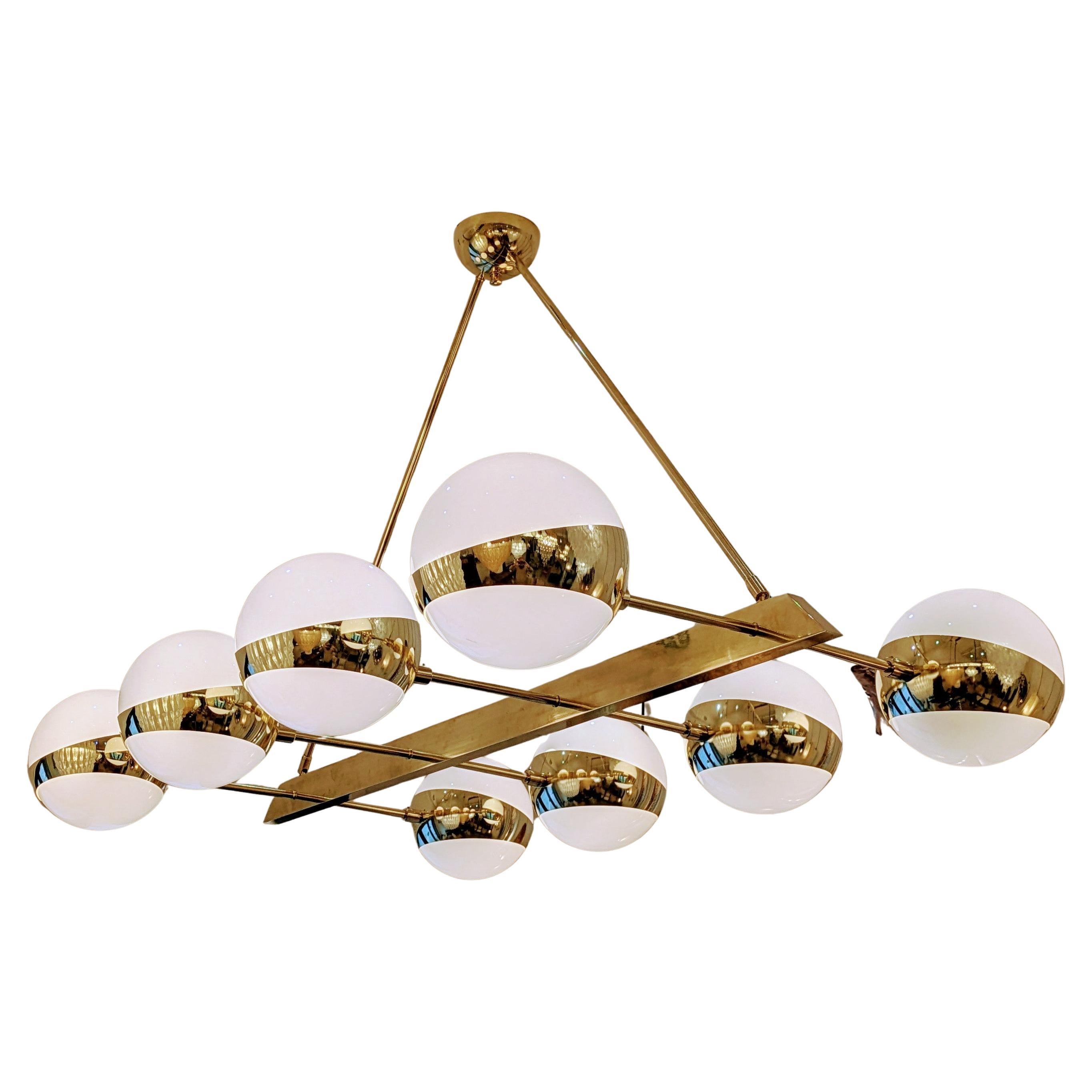 Eight glass globes brass chandelier