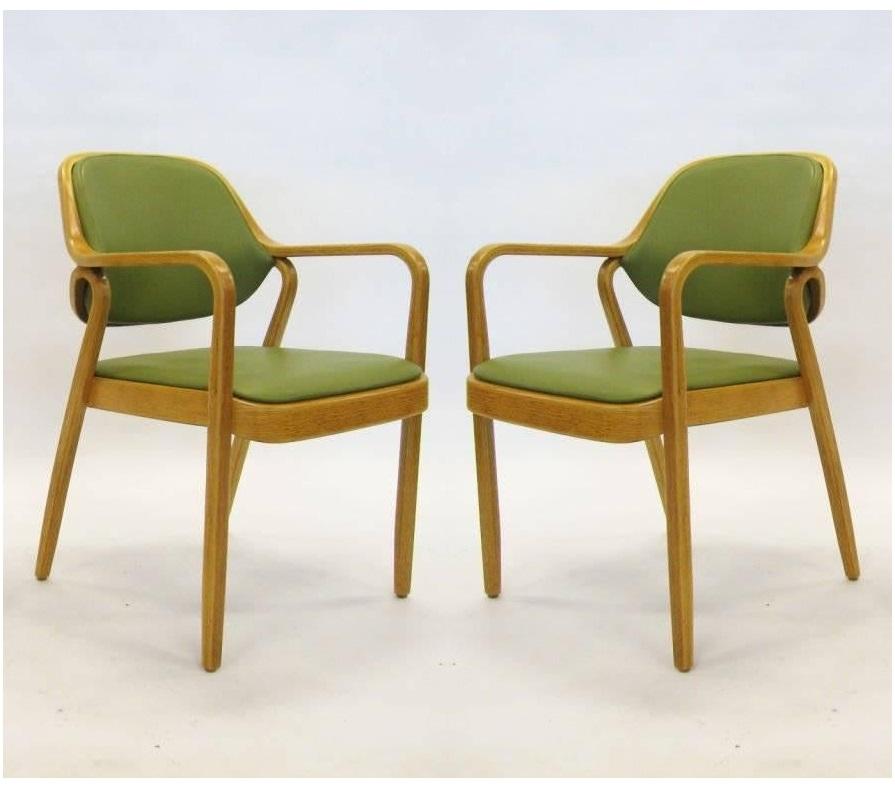Bentwood armchairs by Don Petitt for Knoll. Two lengths of pressed and bent layers of sculpted wood make up the legs and arms as well as the seat back frames. Chairs feature green upholstery that compliments the light wood frames beautifully. These