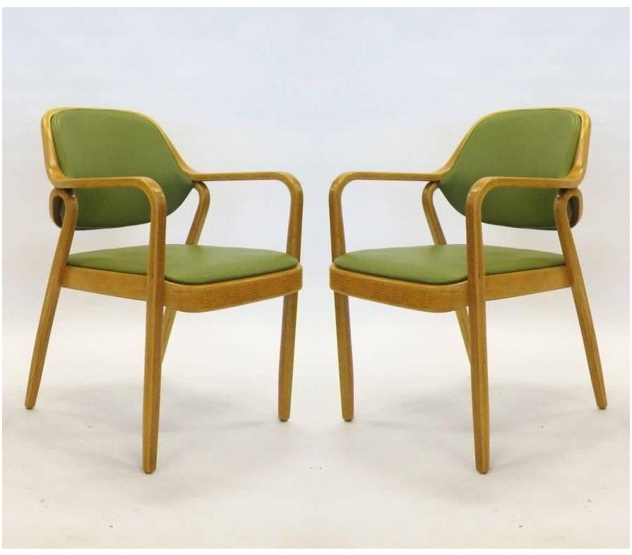 Bentwood armchairs by Don Petitt for Knoll. Two lengths of pressed and bent layers of sculpted wood make up the legs and arms as well as the seat back frames. Chairs feature green upholstery that compliments the light wood frames beautifully. These