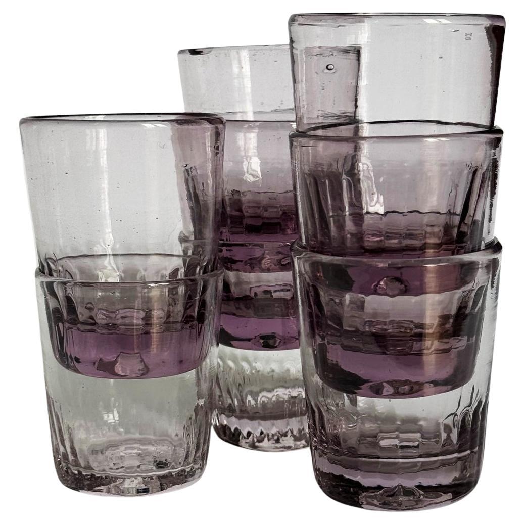 Eight hand-blown Gustavian shots made in Provincial Sweden in Amethyst tones.  It is a reminiscent of a bygone era of peoples gatherings. Each glass bears the subtle imperfections and characterful quirks that are the hallmark of artisanal