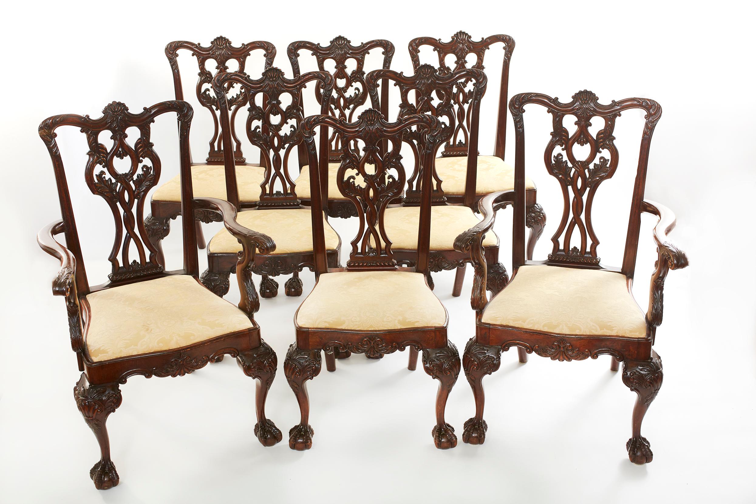 Beautifully hand carved mahogany wood set of 8 dining chairs. The set consist of six side chairs and two armchairs. constructed in mahogany, which has been excellently and comprehensively carved; rising from cabriole front legs, with ball and claw