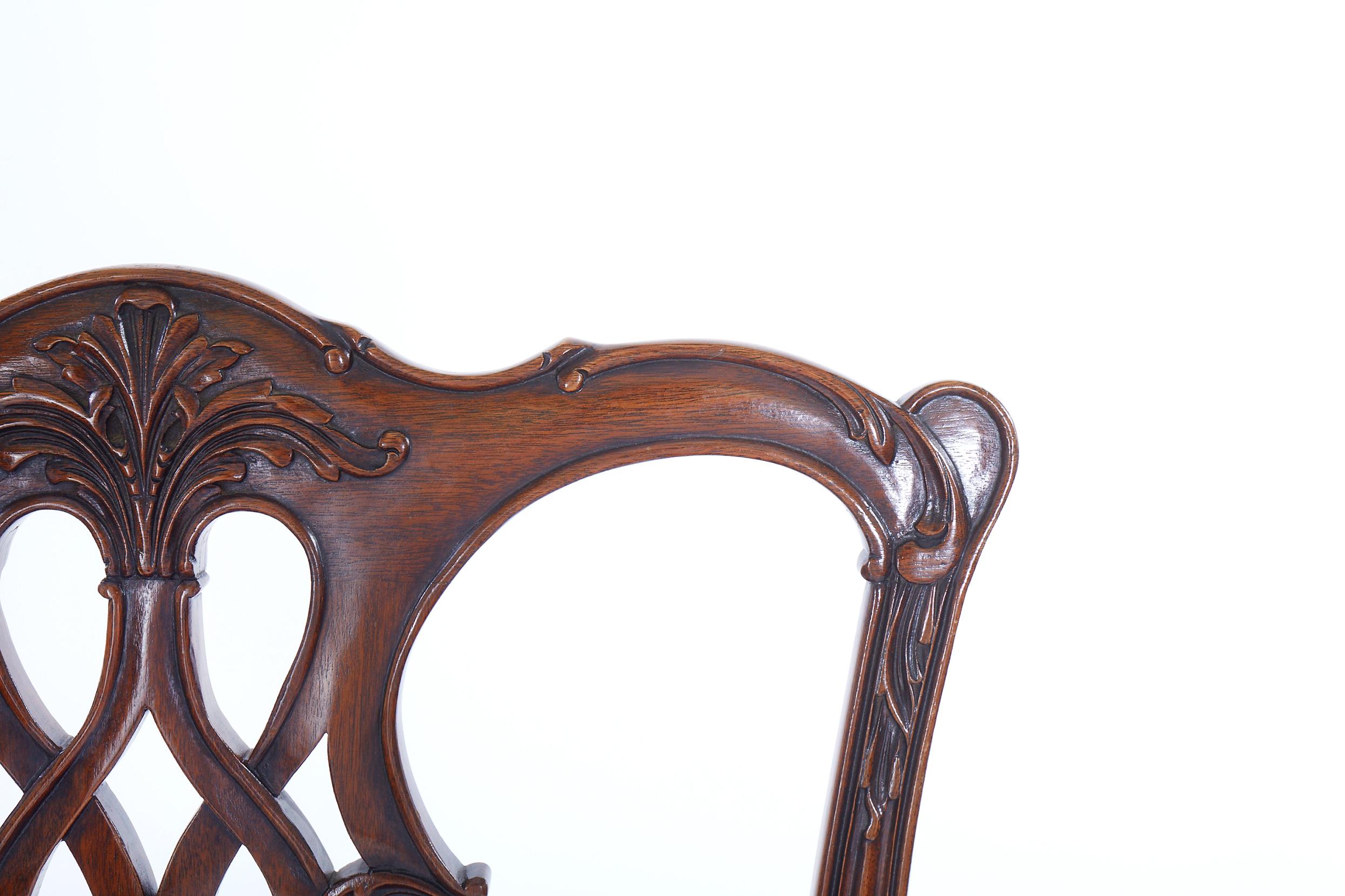 Beautifully hand carved mahogany wood set of 8 dining chairs. The set consist of six side chairs and two armchairs. Constructed in mahogany, which has been excellently and comprehensively hand carved in the chippendale style. Each chair is in great