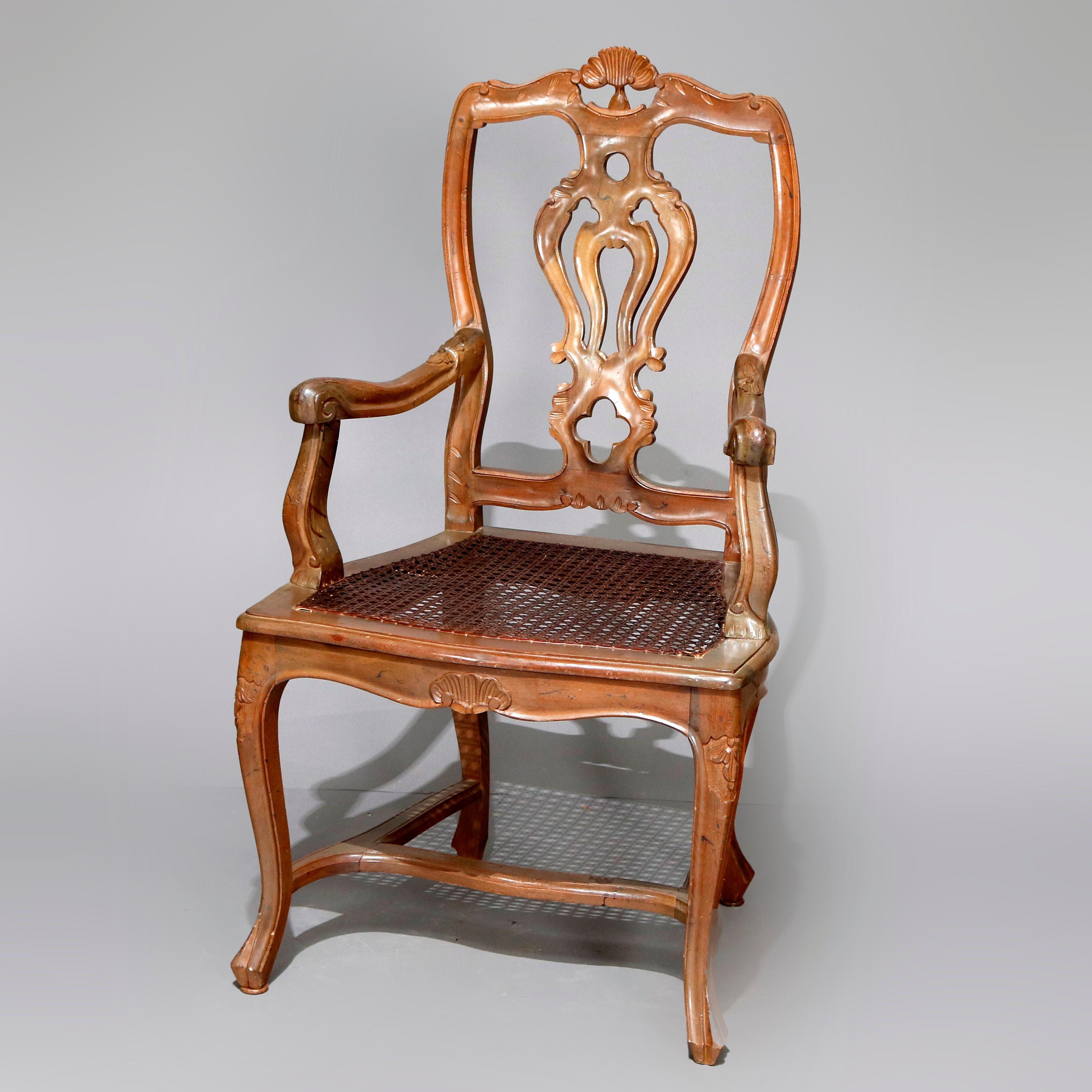 A set of 8 Italian Renaissance dining chairs offer carved fruitwood frames with pierced foliate crest over shaped ribbon backs surmounting caned seats raised on cabriole legs, 20th century.


Measures: 41.25
