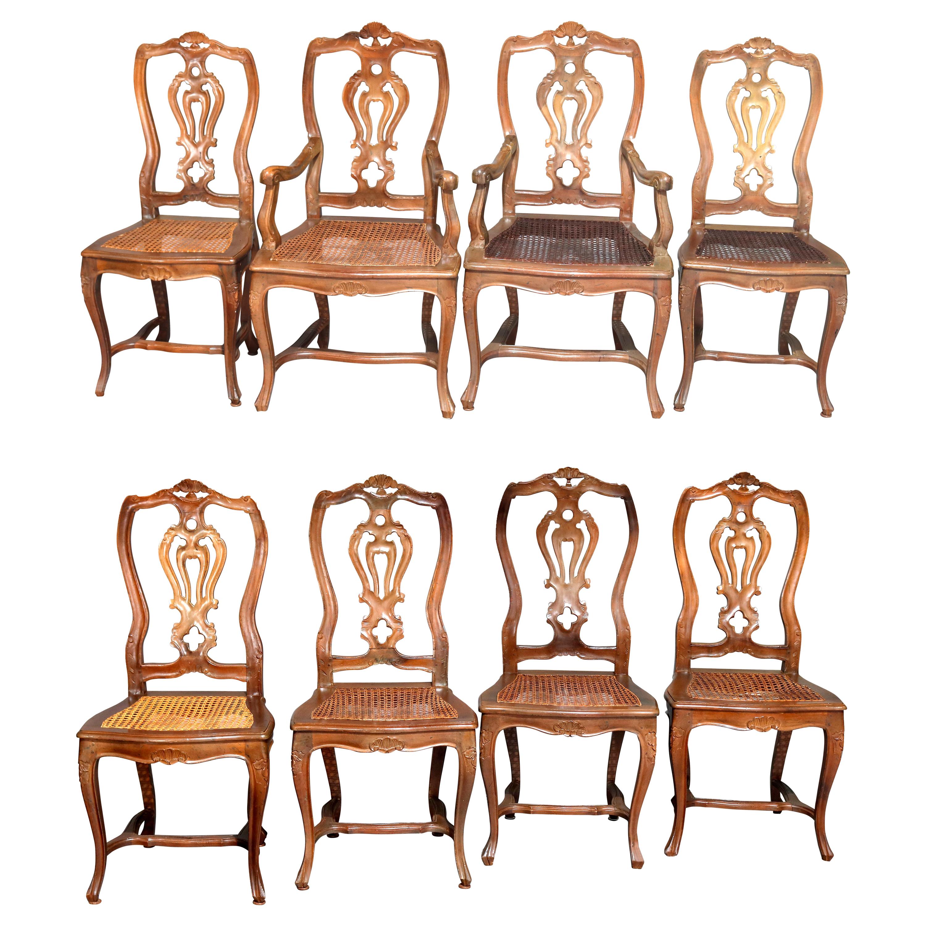 Eight Italian Renaissance Revival Carved Fruitwood and Caned Dining Chairs