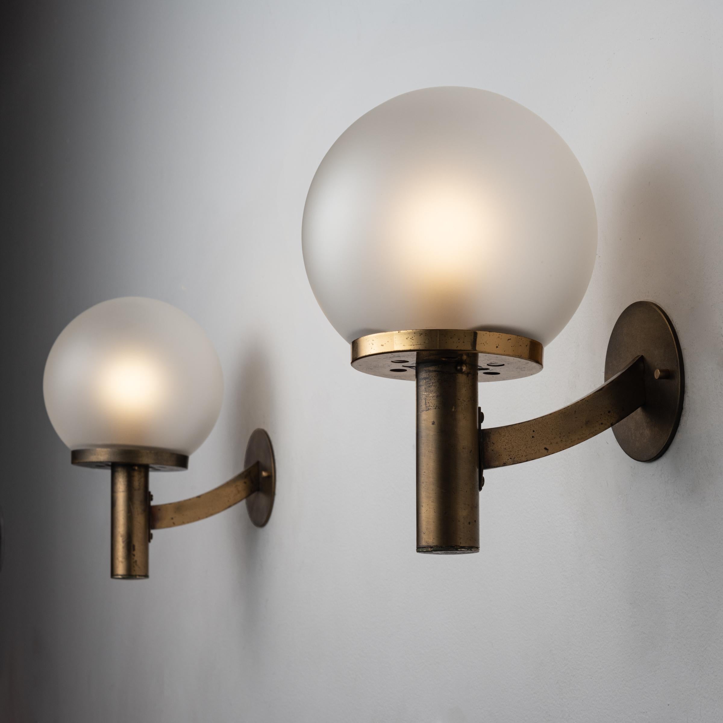 Two Italian Sconces. Designed and manufactured in Italy, circa 1950's. Opaline glass diffuser, brass. Custom brass backplates. Wired for U.S. standards. We recommned one E14 candelabra 60w maximum bulb per light. Bulbs not included. Priced and sold