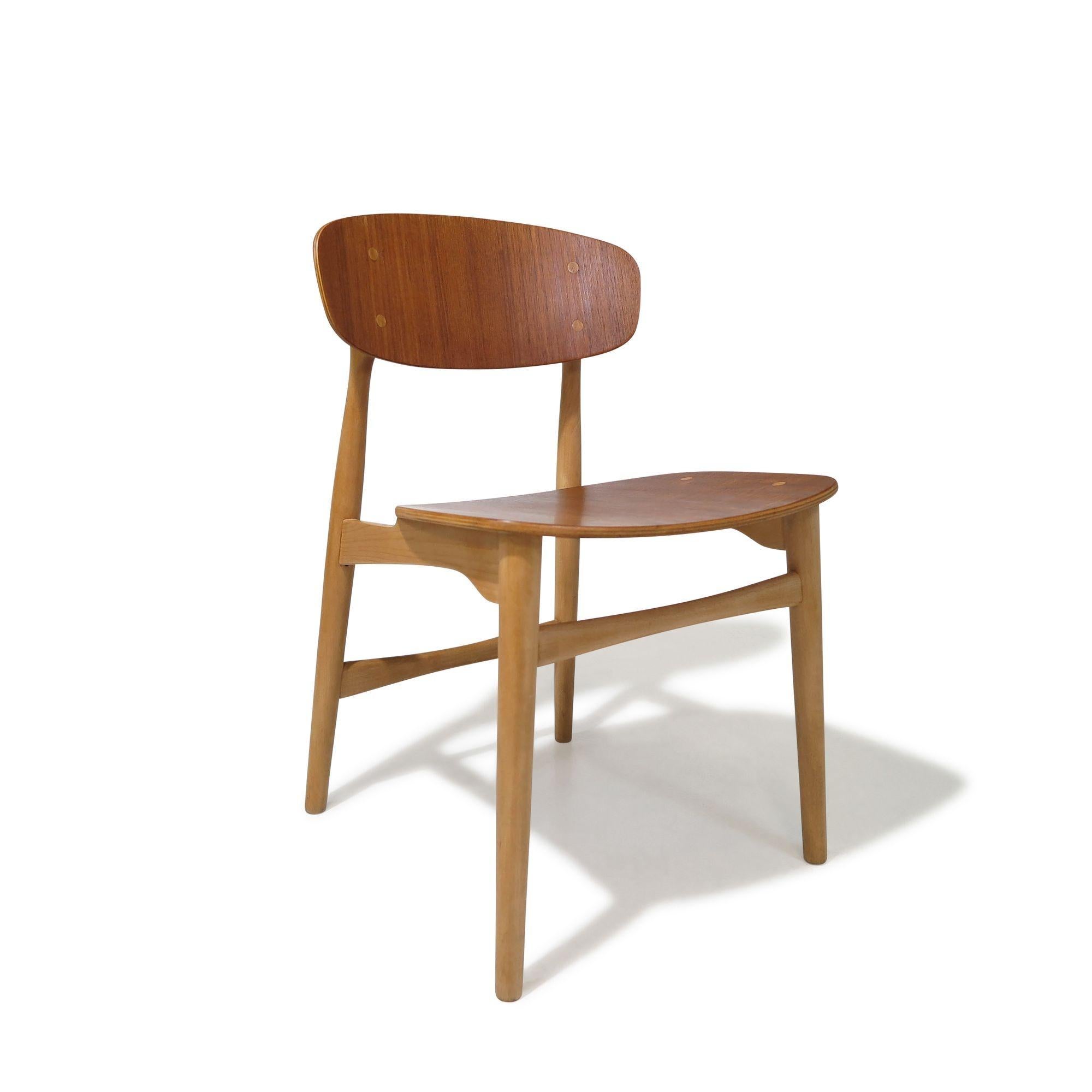 Mid-century Danish dining chairs designed by Jens Hjorth and manufactured by Randers Stolefabrik, Model 308, Denmark, circa 1954. Crafted from solid beech frames with a wax finish and oiled teak backs. The chairs feature curved seats and teak back