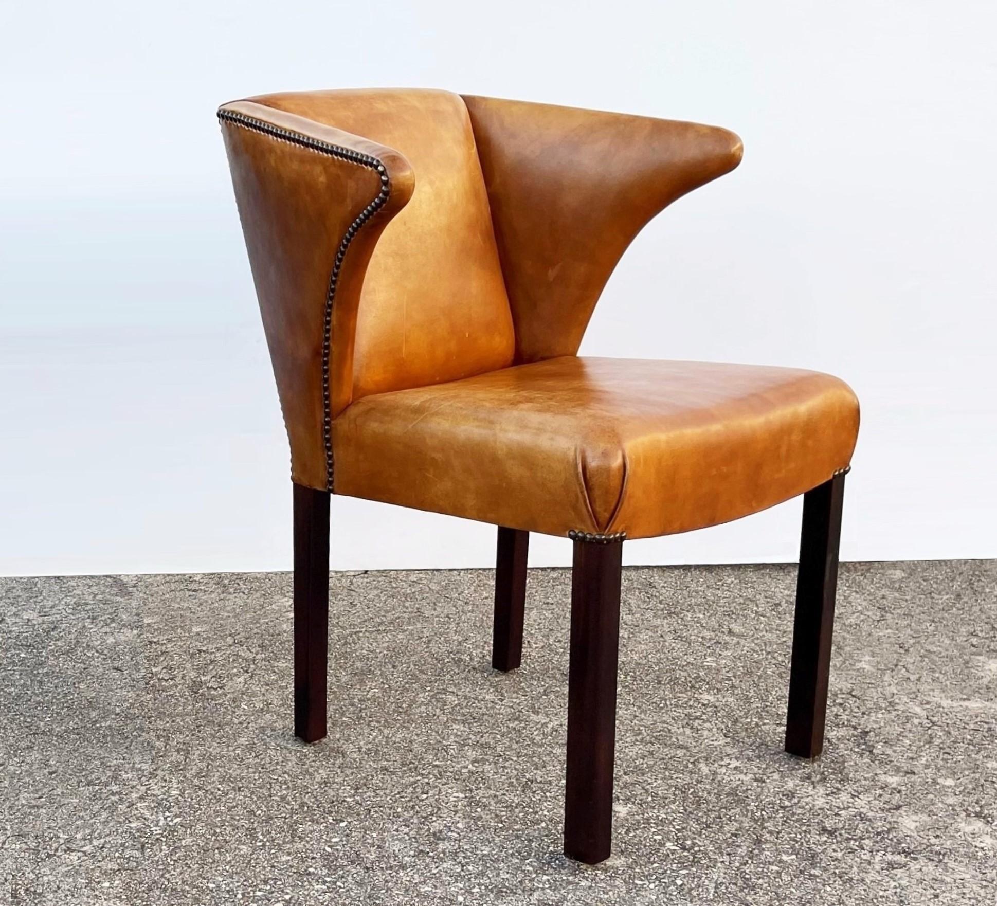 An extremely graceful design, eight dining chairs attributed to Frits Henningsen. The frames with rare form executed in the finest hand dyed leather with nailhead trim, on rich dark mahogany frames. The leather seats have a wonderful color and