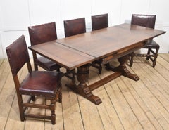 Eight leather upholstered oak dining chairs