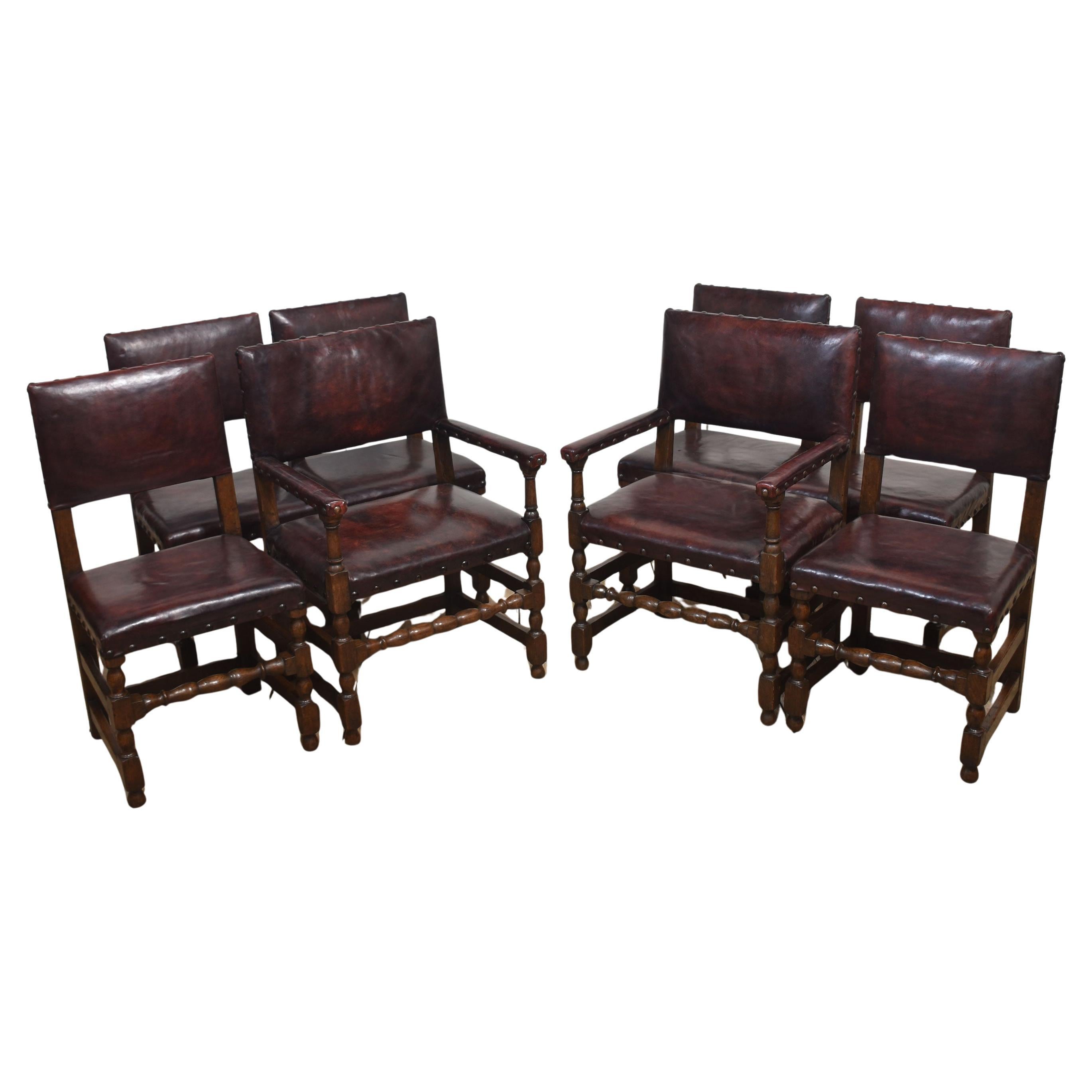 Eight leather upholstered oak dining chairs