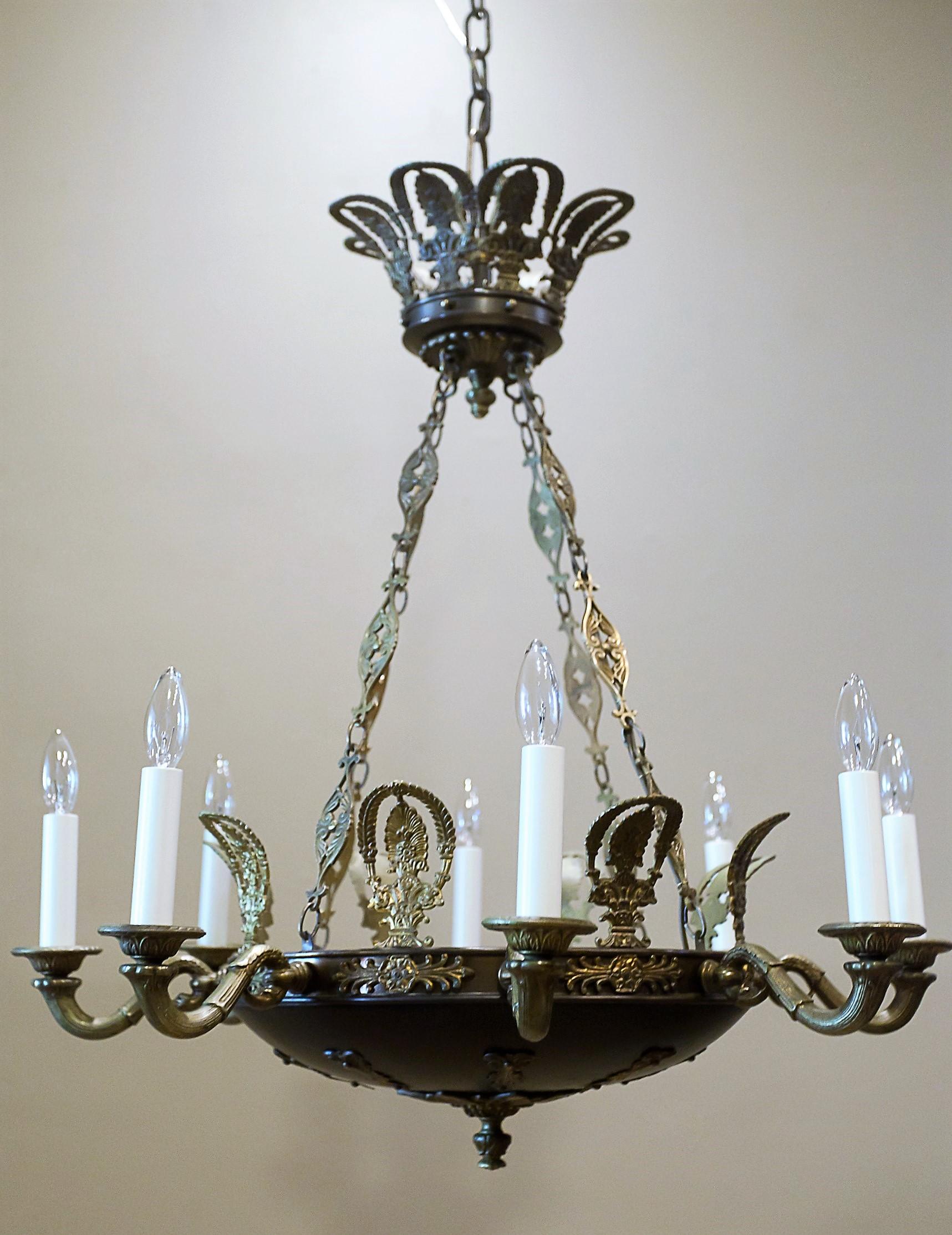 Hand cast brass and patinated brass. The parts for this chandelier were probably cast in Europe for an American manufacturer and assembled in the United States; hence the patent number impressed on the bobeches. Height can be shortened slightly.