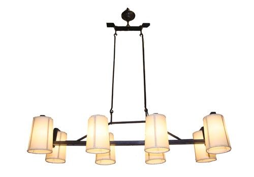 A new eight-light hand forged iron horizontal chandelier with two rods suspended from ceiling mounted U shaped horizontal bar securing hand forged rods attached to body of chandelier and with faux goat skin handstitched wax paper shades. Three