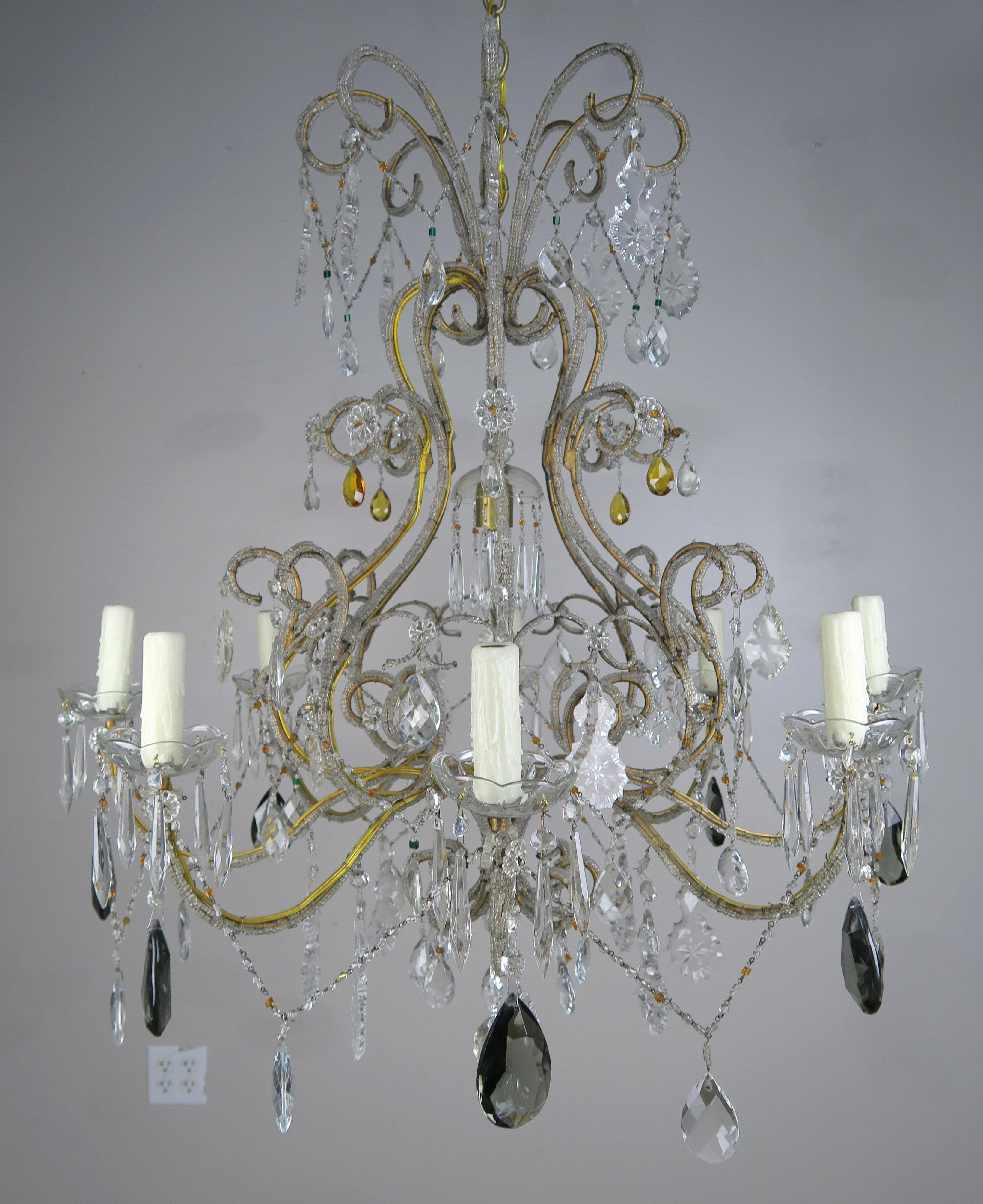 Eight light Italian crystal beaded arm chandelier with scrolled arms ending in drip wax candles. A large smokey crystal hangs from each arm and are combined with clear crystals throughout. The chandelier is newly rewired and includes chain and