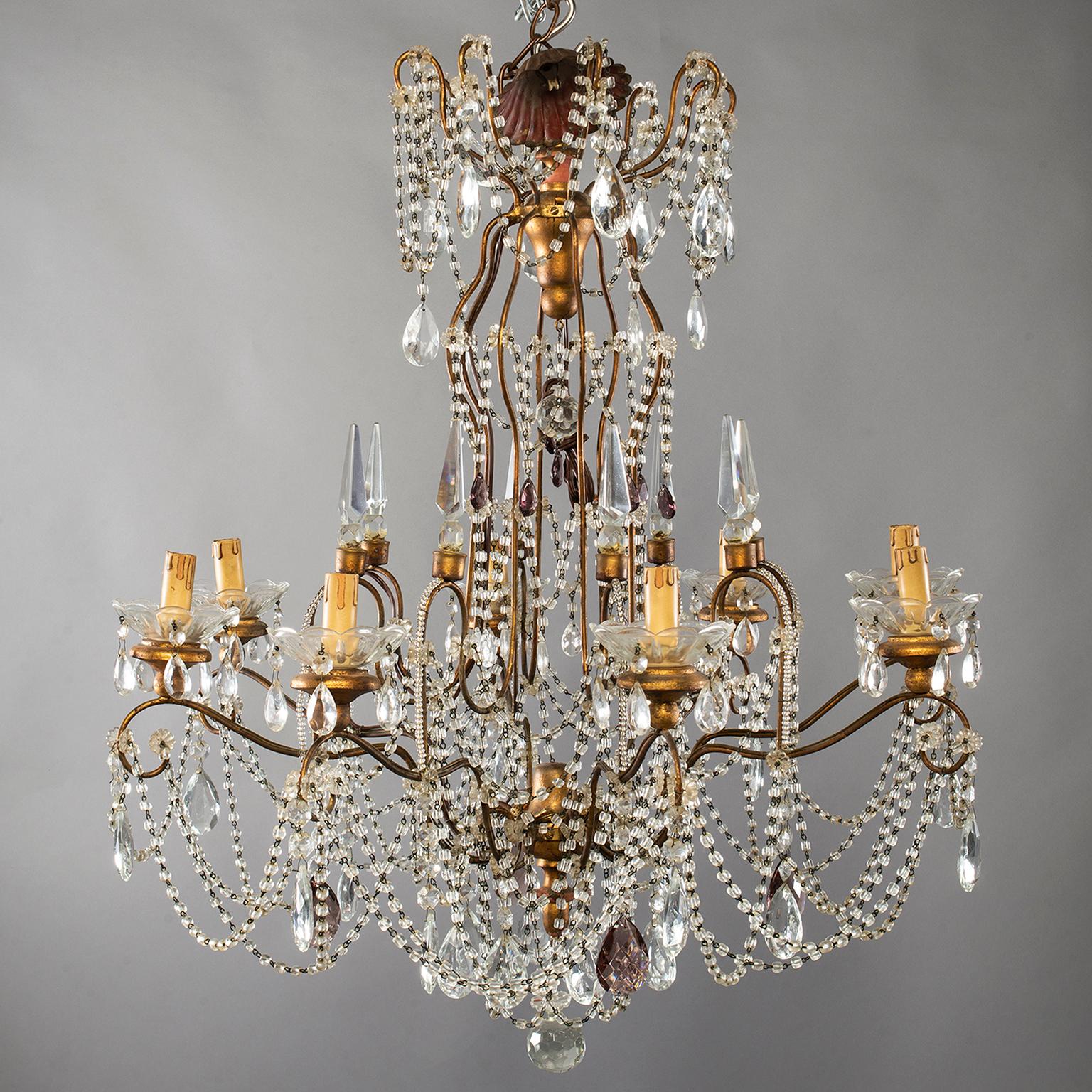 Eight-light Italian Crystal chandelier with giltwood Bobeches

large Italian crystal chandelier with brass frame, eight candle style lights, giltwood bobeches, large faceted crystal drops and crystal beading, circa 1920s. New wiring for US