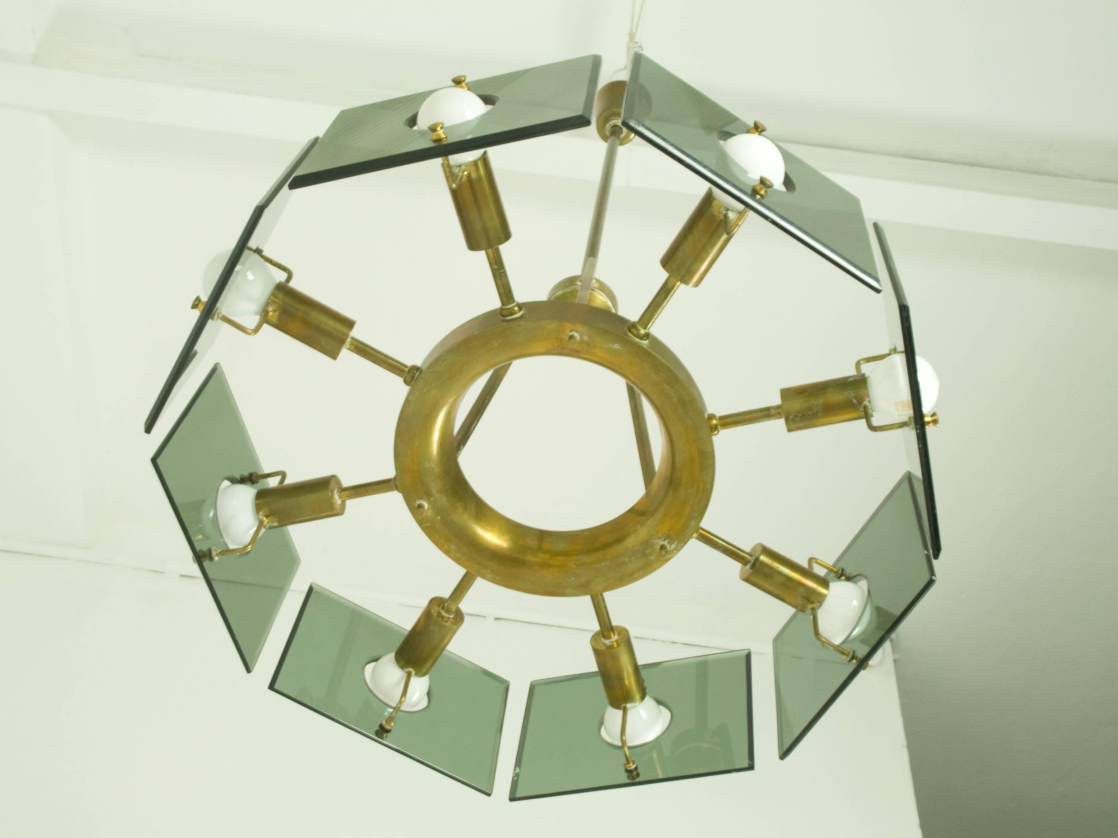 This elegant chandelier was manufactured in Italy in the 1960s. It was produced by crystal Arte with a brass structure and eight cut-glass square shades. This pendant features an eight-lights electrical system and remains in a overall very good