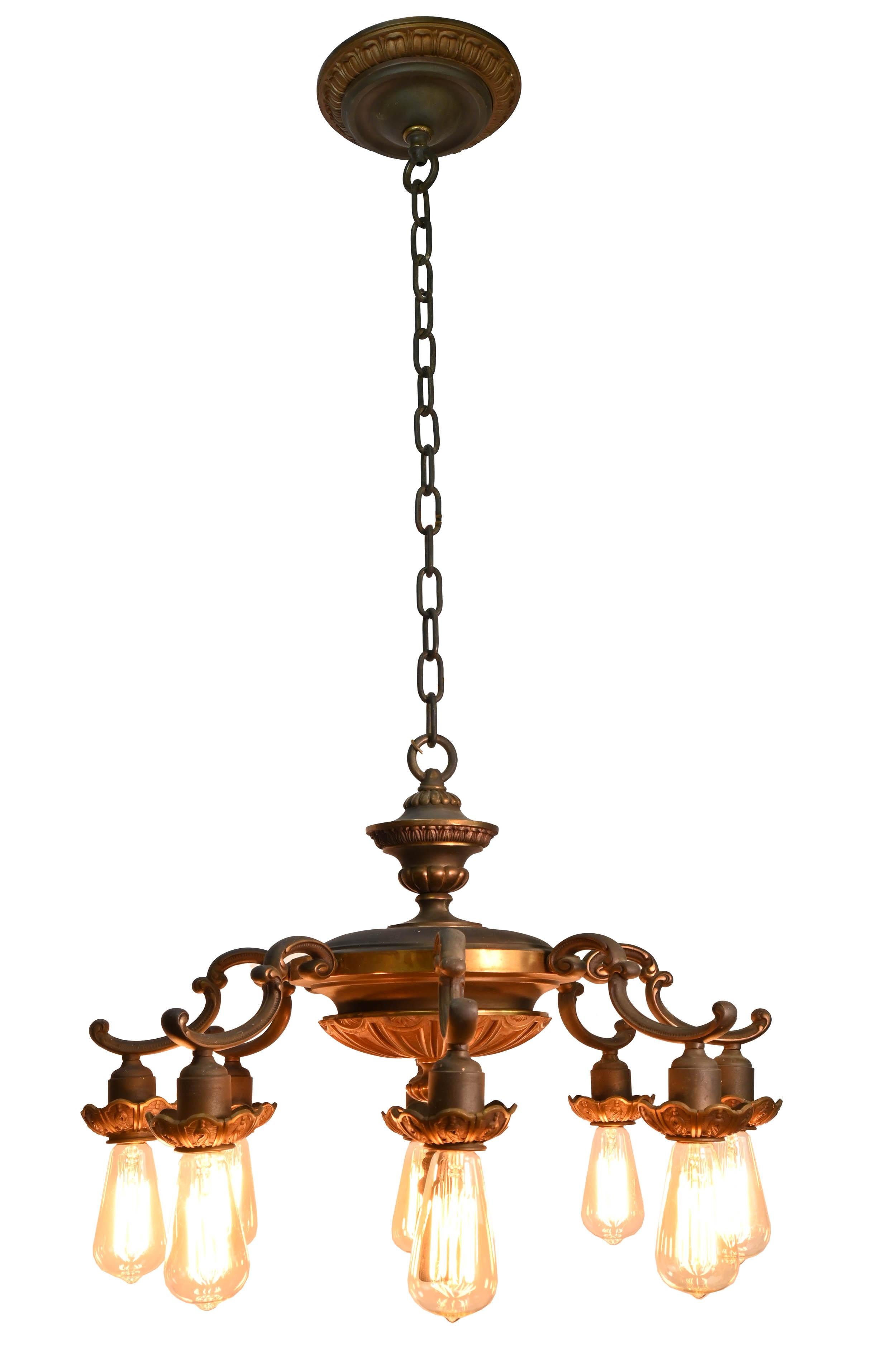 It’s rare that we find lights like this in quantity,

circa 1920s
Condition: Age consistent/Good
Material: Cast and stamped brass
Finish: Original
Country of origin: USA
Illumination: 8 standard Edison sockets

Dimensions: 25” diameter by