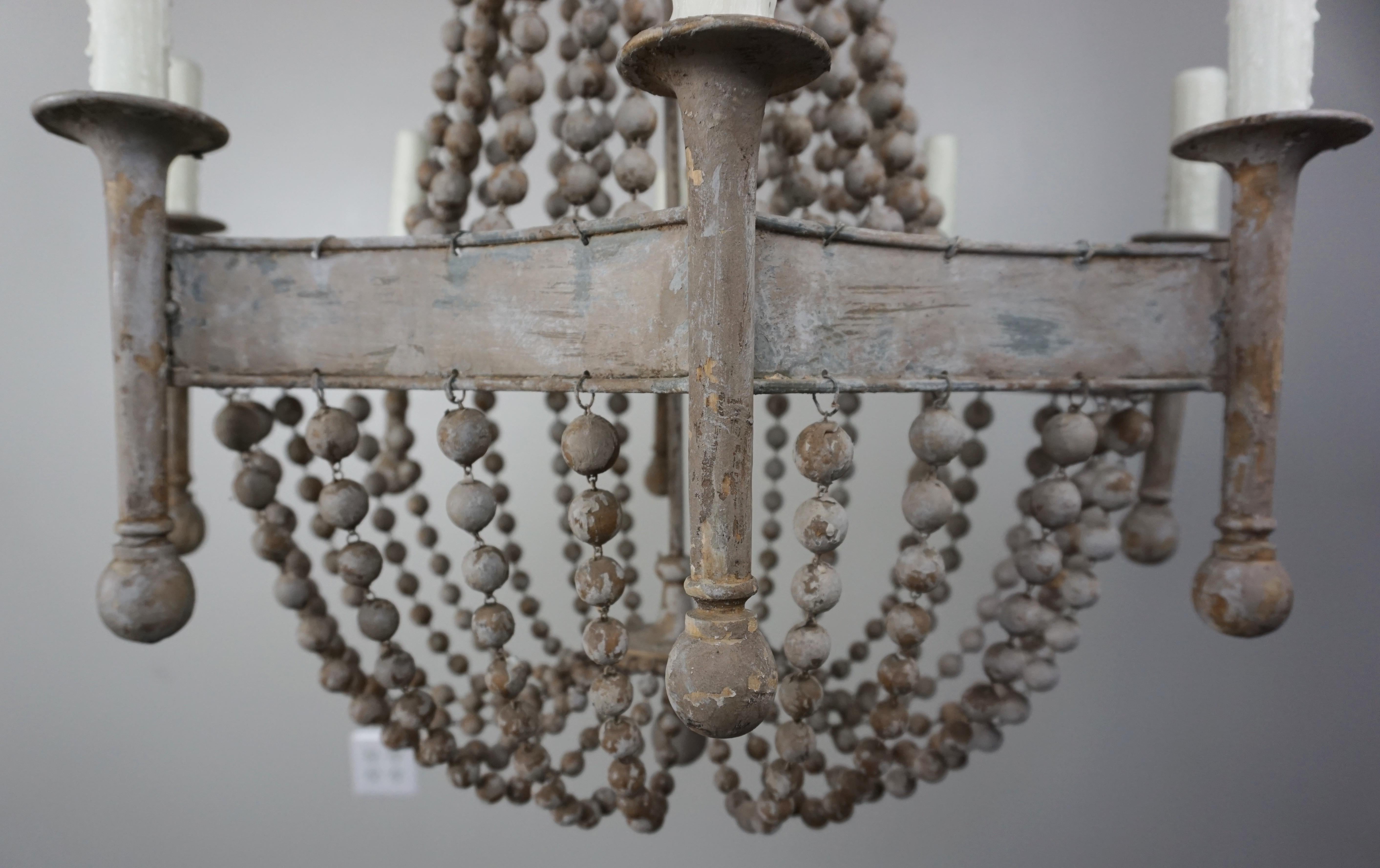Eight Light Painted Wood Beaded Chandelier In Distressed Condition In Los Angeles, CA