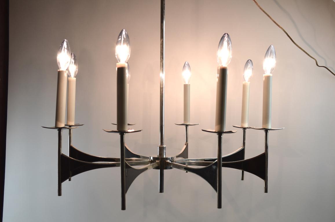 Sophisticated spoke form chandelier by Sciolari. Eight arms each having a candle light bulb. Silver plated brass with decorative gun metal trim. The metal finish shows some cosmetic wear, normal and consistent with age. Original, working condition -