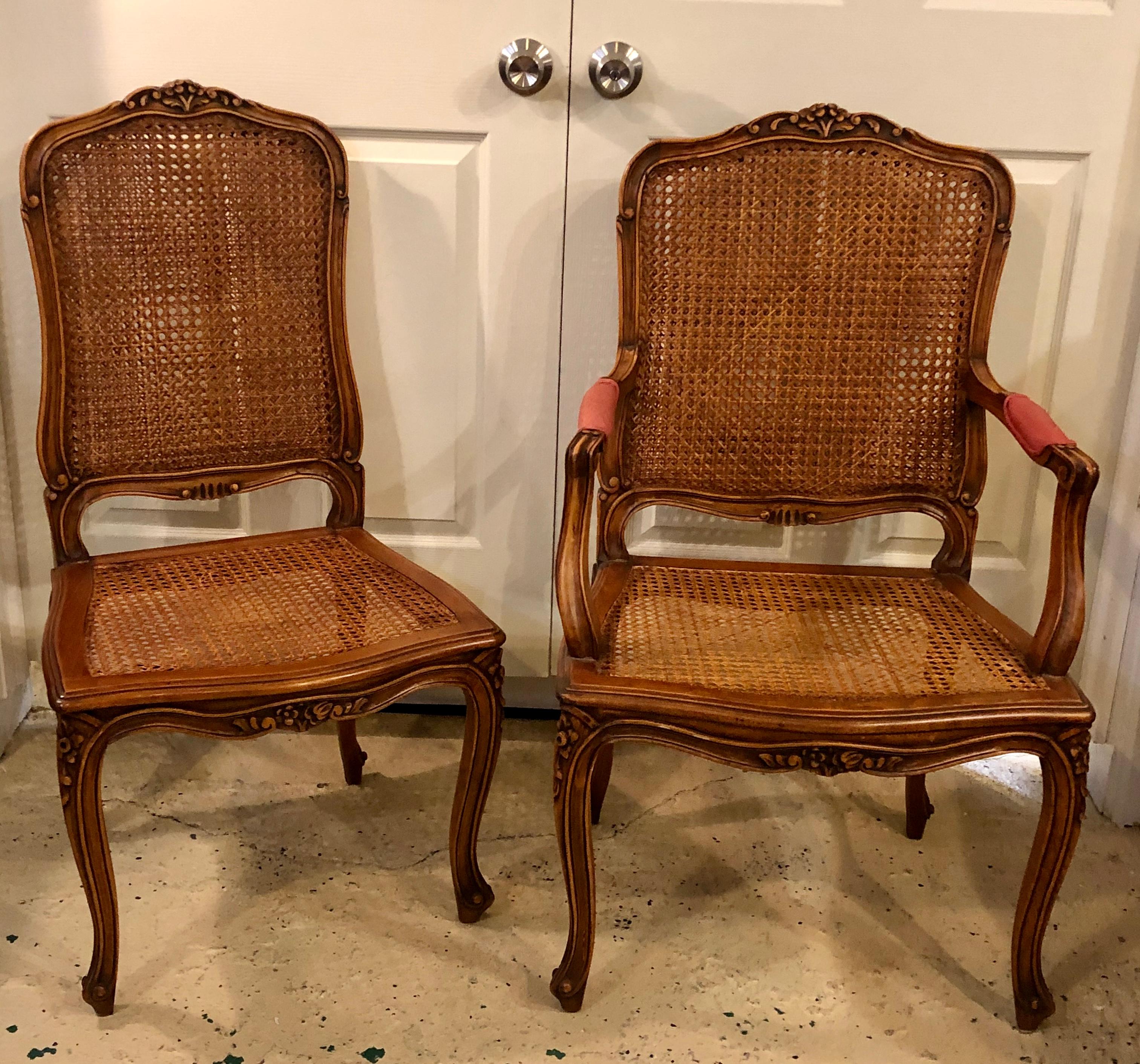 Eight Louis XV style country French dining chairs. This extraordinary finely carved set of dining chairs have double cane on the backrests and come with custom cushions. The cushions are in good condition however, they need to be cleaned. Each of
