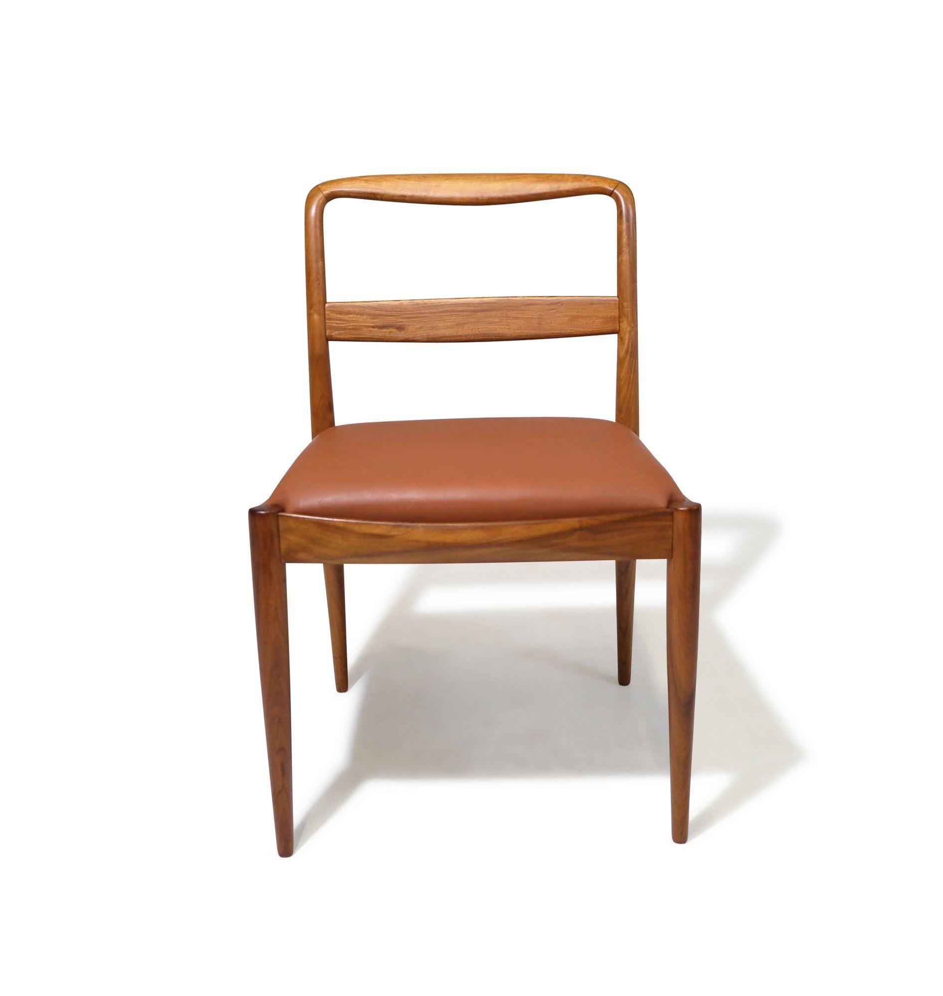 Elegant set of eight Brazilian Modern dining chairs produced by Liceu de Artes e Officios, 1955, in Sao Paulo Brazil. Hand sculpted of beautifully grained Caviuna tone-wood with with a ladder back design featuring two slats newly upholstered seats