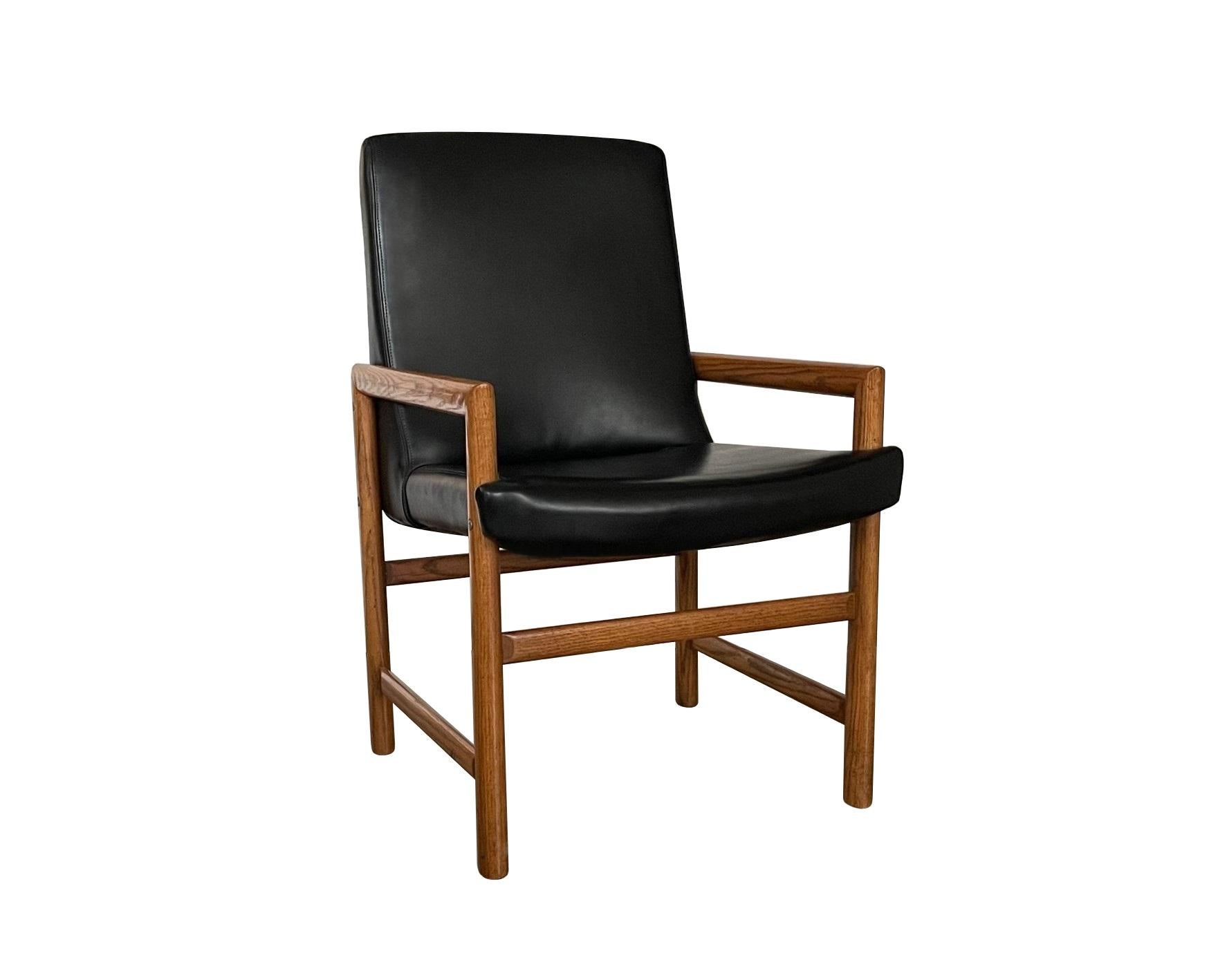 Mid-Century Modern sophistication, for your consideration is a fantastic set of dining armchairs, circa 1970s. A sleek, Minimalist Silhouette with sharply angled arms, built geometrically, blending in aesthetic while lending support and comfort.