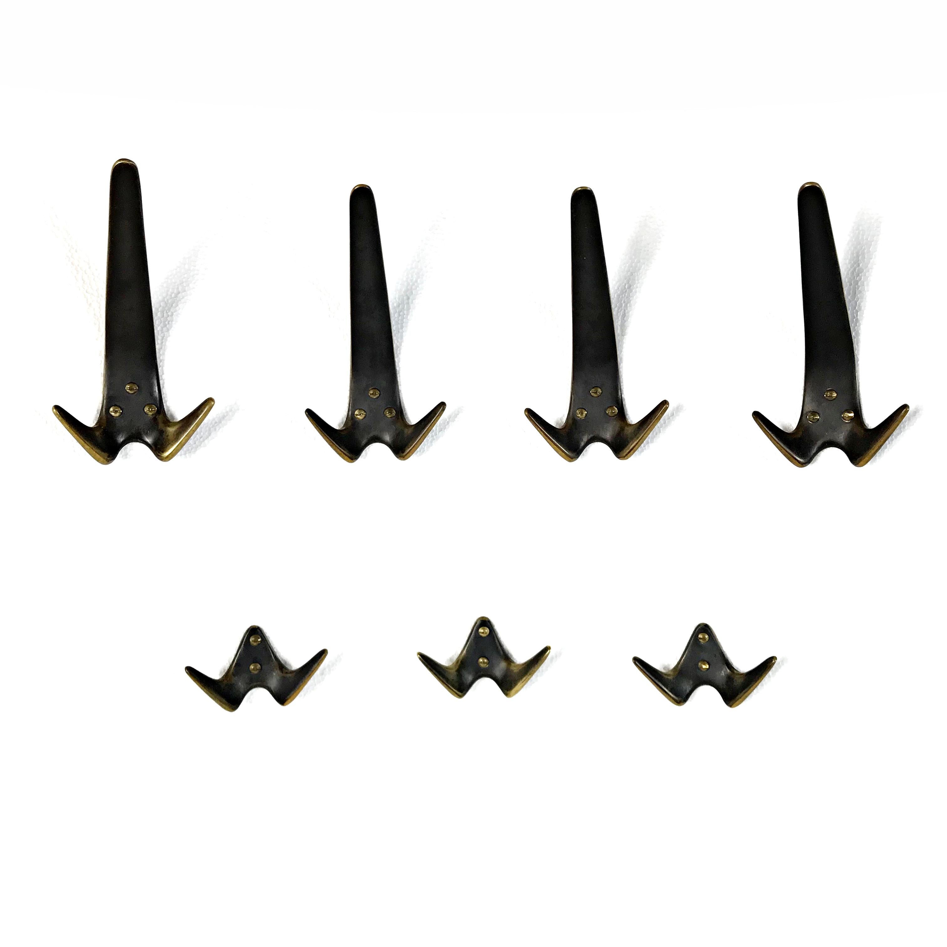 Ten beautiful Austrian Mid-Century Modern solid brass hooks by Carl Auböck II from 1950s. They are made of polished and patinated solid brass. 
The same hooks were sold at an auction on 13 October 2016 in Chicago for 3.750 $ set of four.
