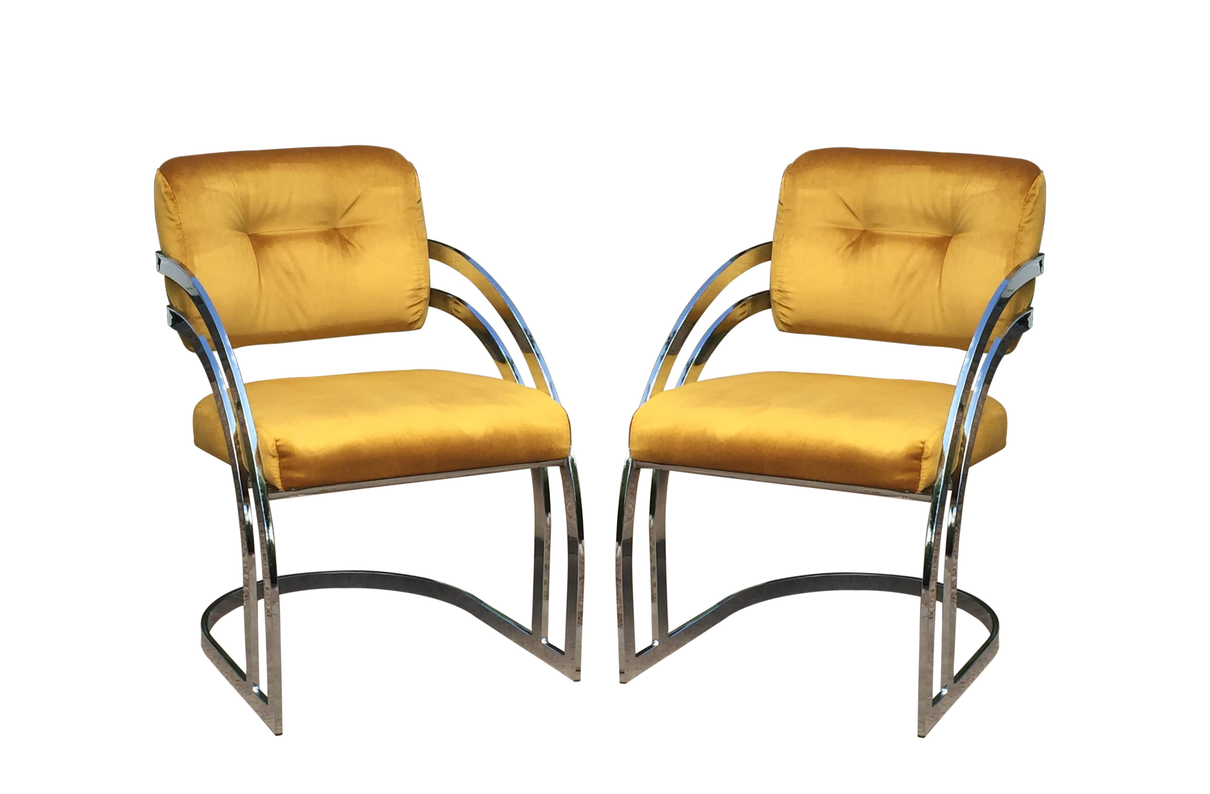 Sculptural chrome dining chairs in the manner of Milo Baughman. Professionally upholstered in a gold colored velvet fabric provides a modern vibe with its chrome frames. The chair backs have a triple bar design and waterfall cantilevered frames