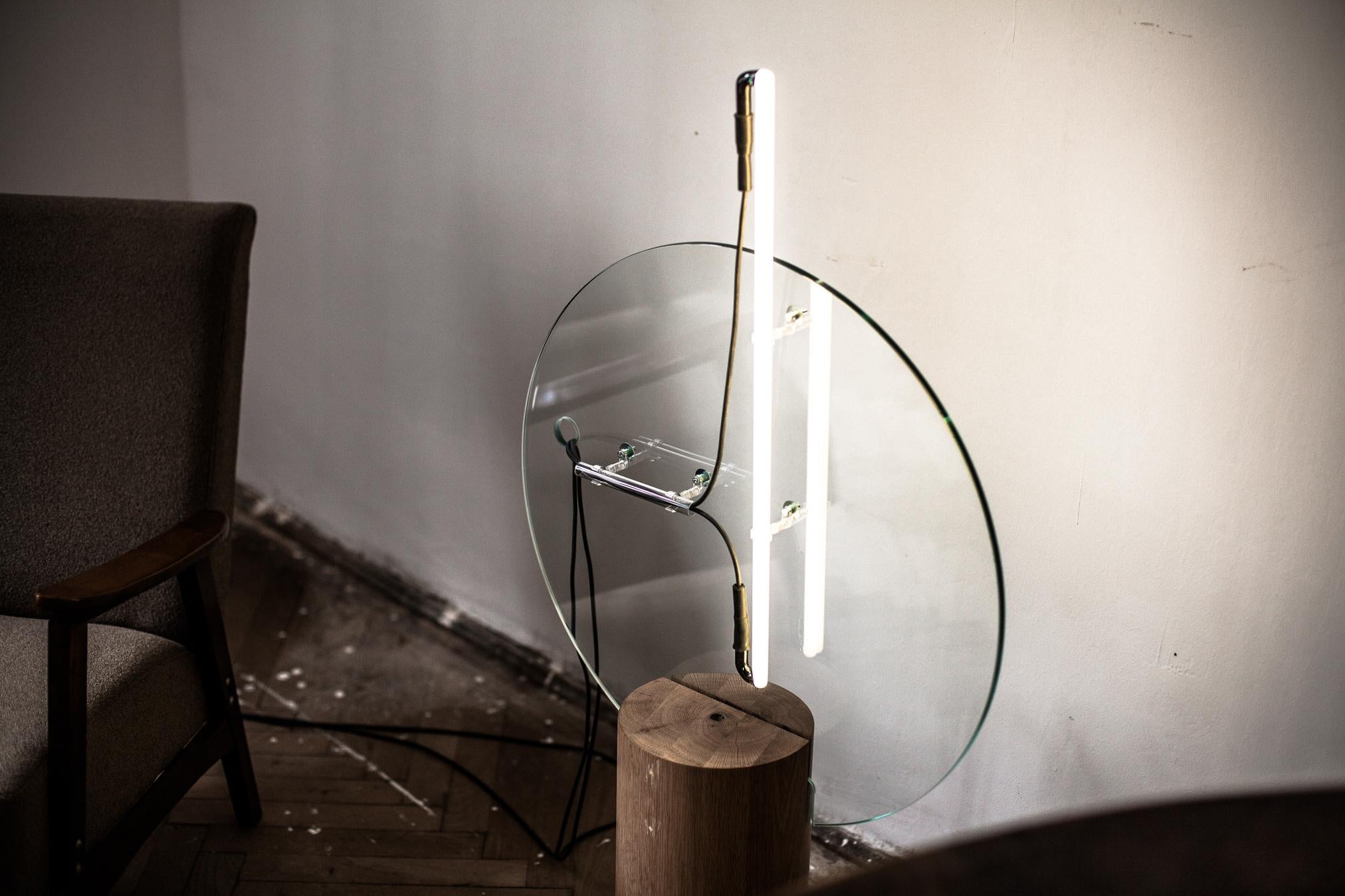 “Eight minutes old” is a family of sculptured objects and light installations. They’re part of a small series of two compositions and are made in a composition of wood and glass, using the light tube as a central element. The base of the lamp is a