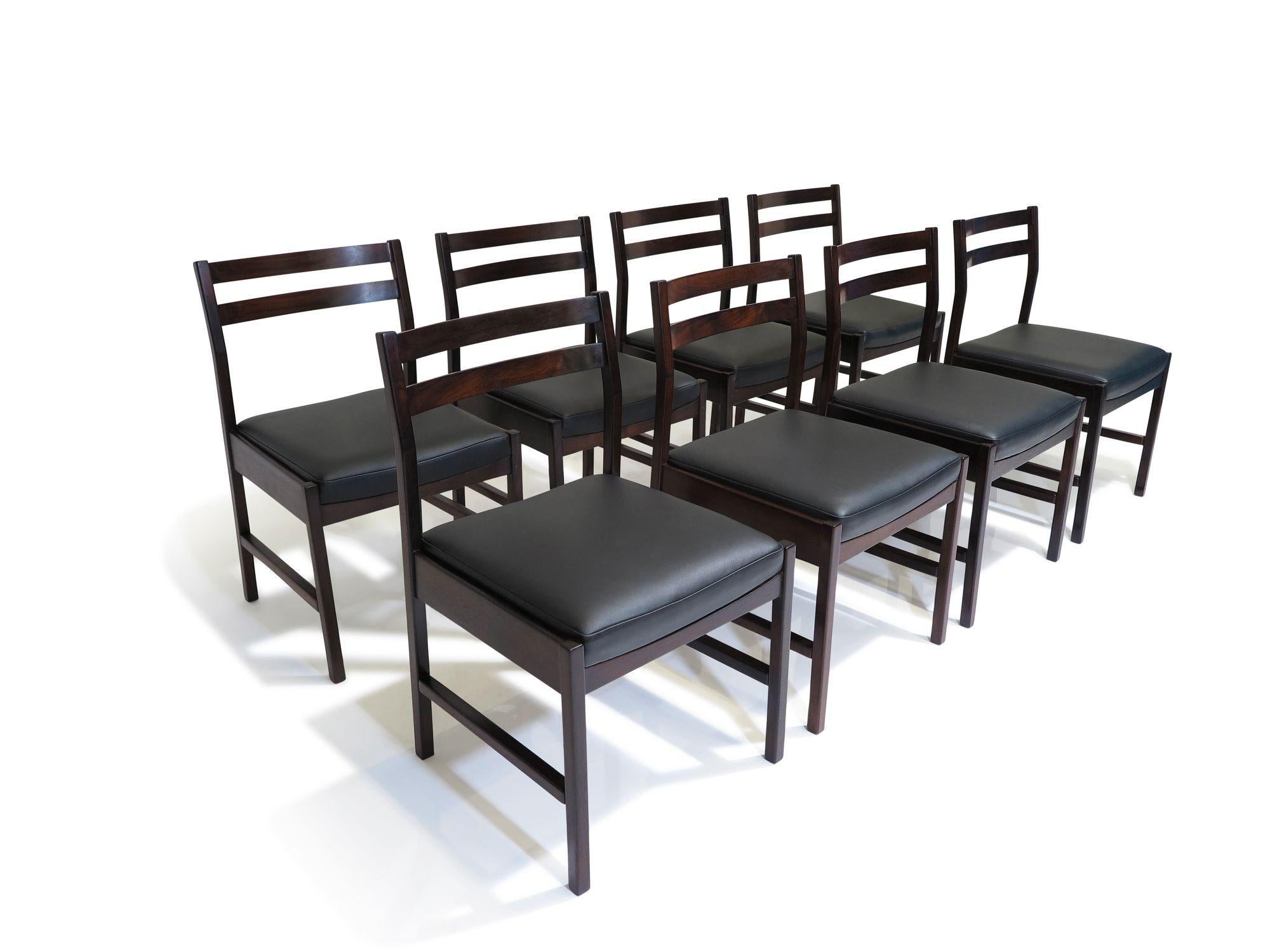 Set of 8 Minimalist Brazilian rosewood dining chairs designed by Vittorio Tassini for Moveis Decoraçoes Tássini, Brazil, 1955. These chairs showcase solid Brazilian rosewood construction with a ladder back design featuring two slats, complemented by