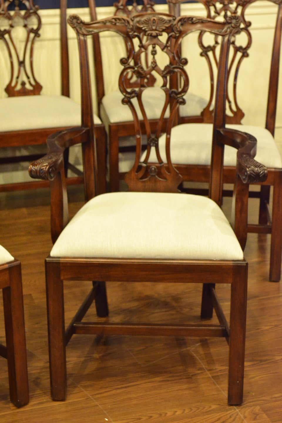 These are new traditional mahogany dining chairs. Their design was inspired by the English Chippendale style straight leg dining chairs from the Georgian period. They feature Classic Chippendale styling with straight legs and intricately carved