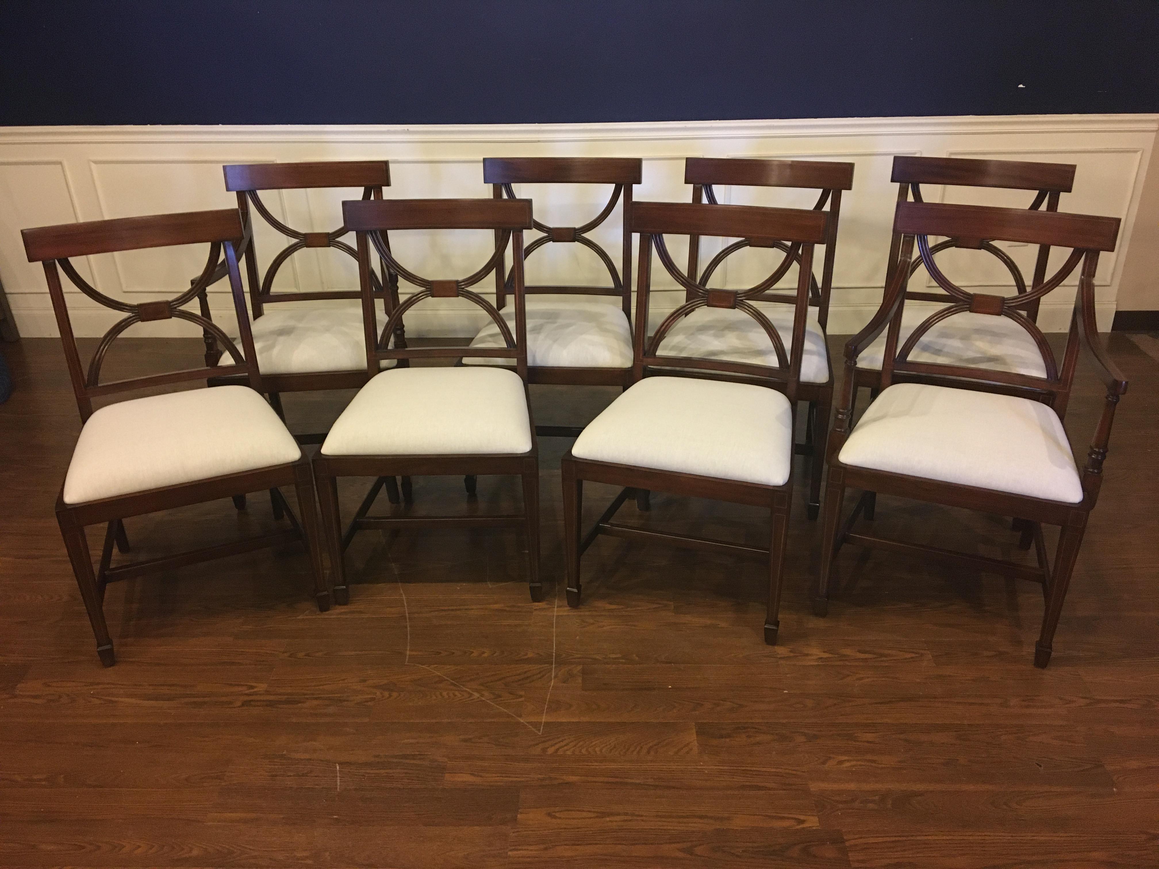 These are new traditional mahogany dining chairs. Their design was inspired by dining chairs from the Regency period. They feature classic Adams styling. They have an understated elegance with square tapered legs and delicate inlays in the backs,