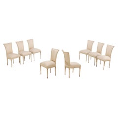 Eight painted and gilt Louis XVI style dining chairs circa 1950.
