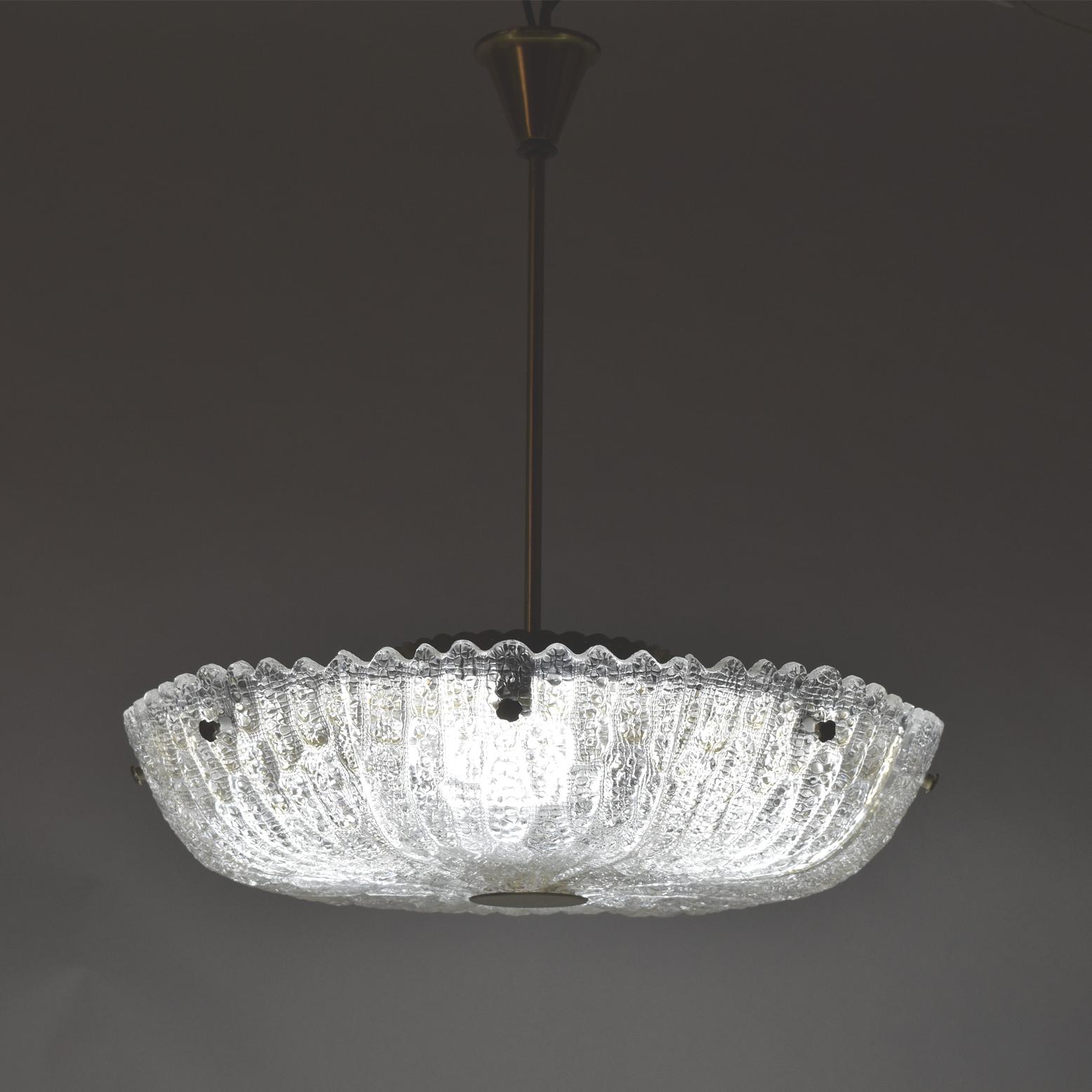 Mold-blown glass Orrefors ceiling lamp, with brass diffuser, rod and decorative screws. Designed by Carl Fagerlund.
