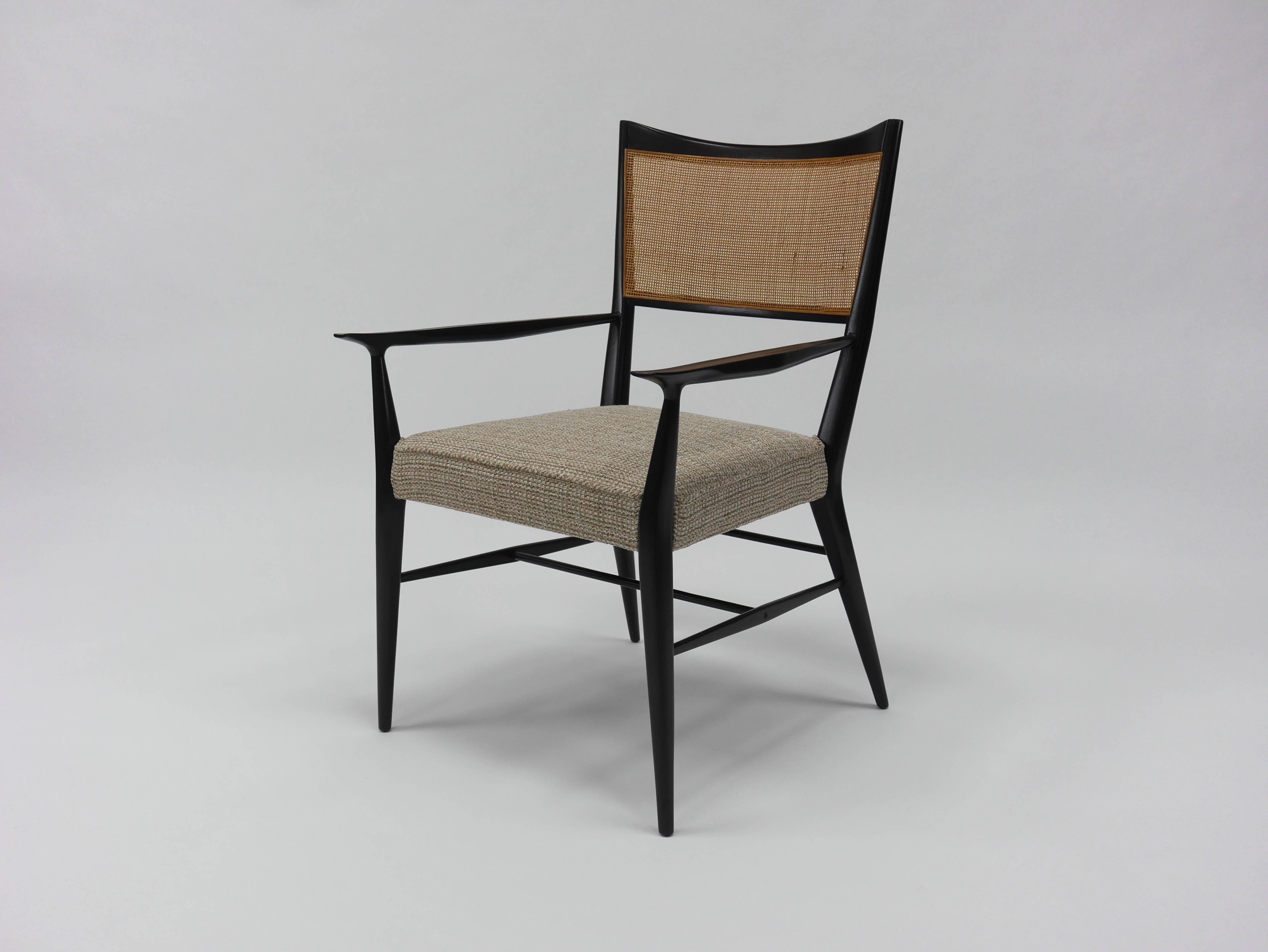 Set of eight Paul McCobb Irwin collection dining chairs with sculpted mahogany frames and caned backs. Six side chairs, two armchairs. Refinished and re caned. Upholstery shown is for reference only, chairs are stripped and ready for client's