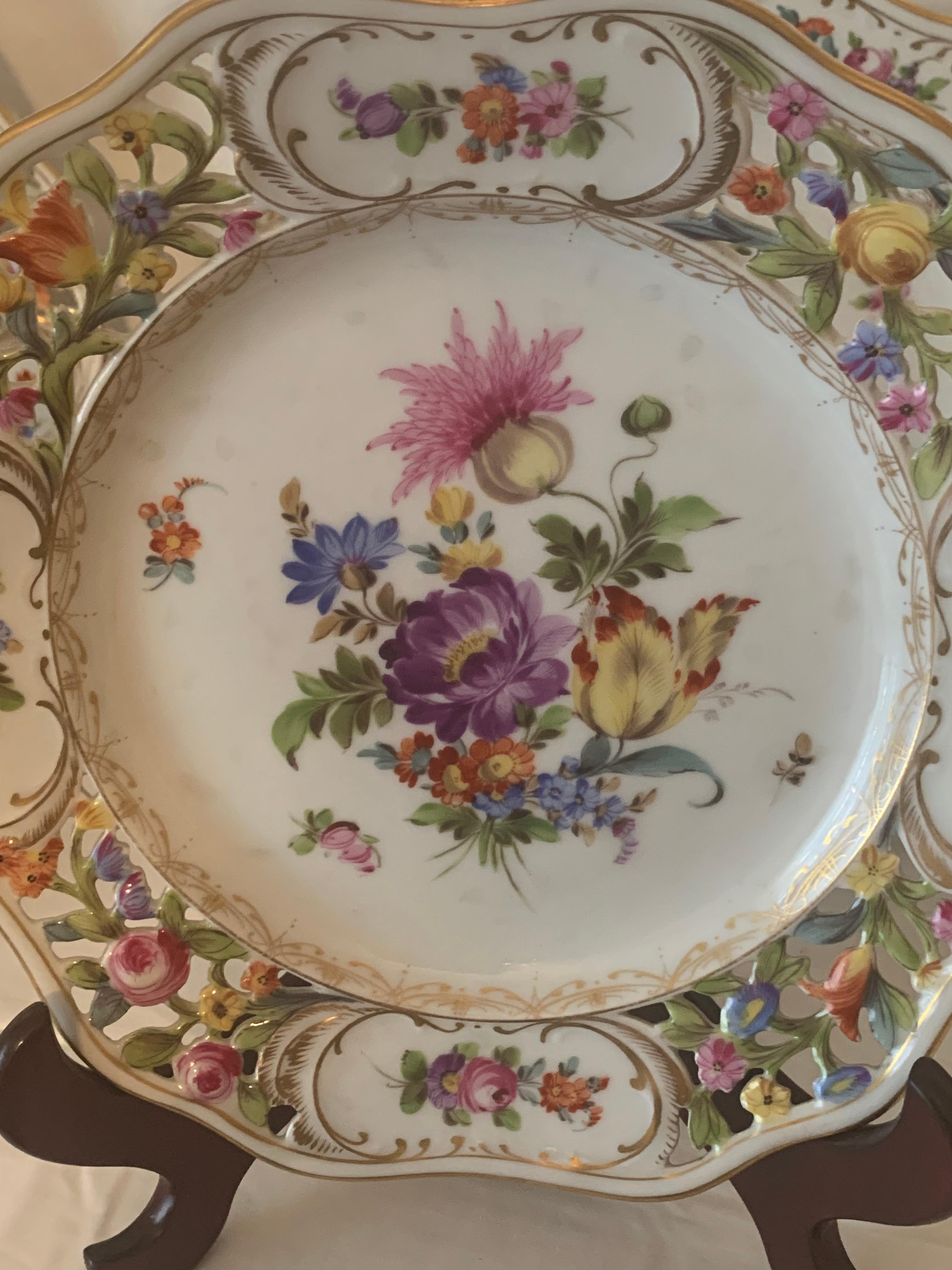 Very beautiful suite of eight plates by dresden porcelain .A scalloped edge and openwork, a reticulated border with panels of garlands of flowers and a paited center with a very beautiful
sprayof flowers finely painted by hand 
simply a very