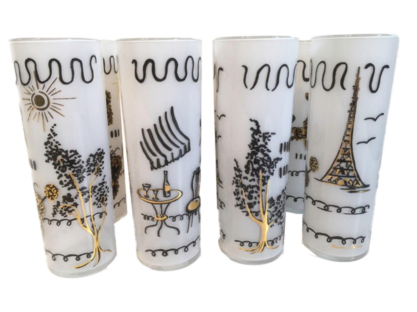 Set of 8 (4 pairs) of vintage Tom Collins glasses, designed by Maida Amour on Libbey glass. Each glass has a French poodle walking on their hind legs. The glass is frosted white on the interior, the exteriors are decorated in black and gold with