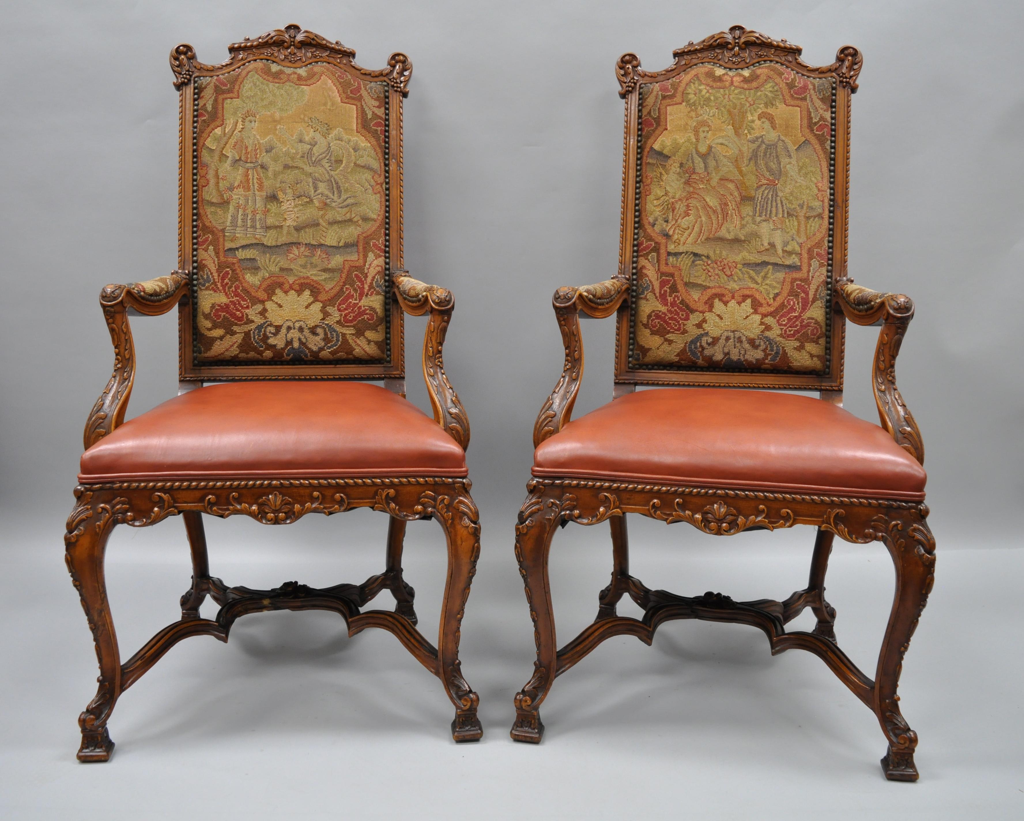 Set of eight Rococo style carved walnut, leather, and needlepoint dining chairs, circa 1900. Set includes two armchairs with figural needlepoint upholstered backs and armrests and leather upholstered seats. The six side chairs having leather