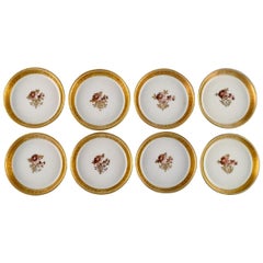 Huit sous-verres à panier Royal Copenhagen en porcelaine dorée à bordure dorée