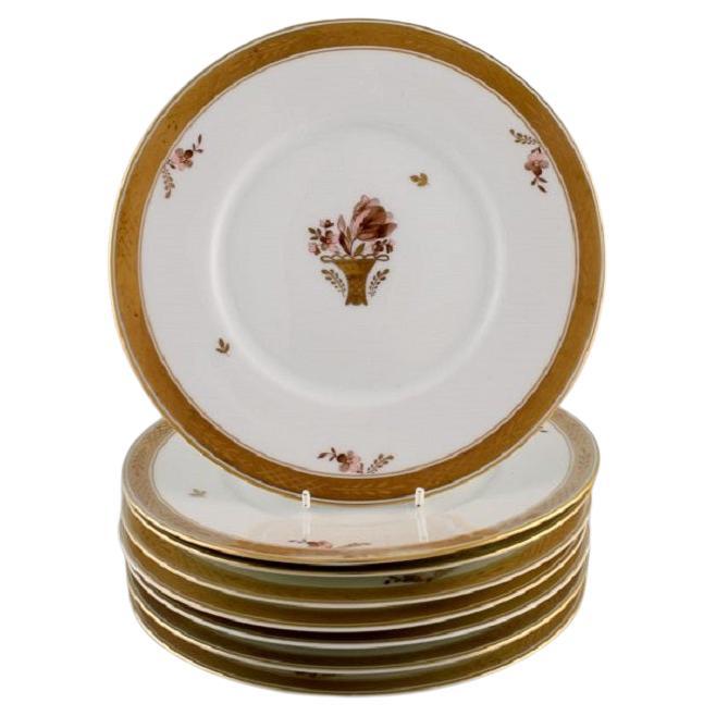 Eight Royal Copenhagen Golden Basket Plates in Porcelain with Flowers