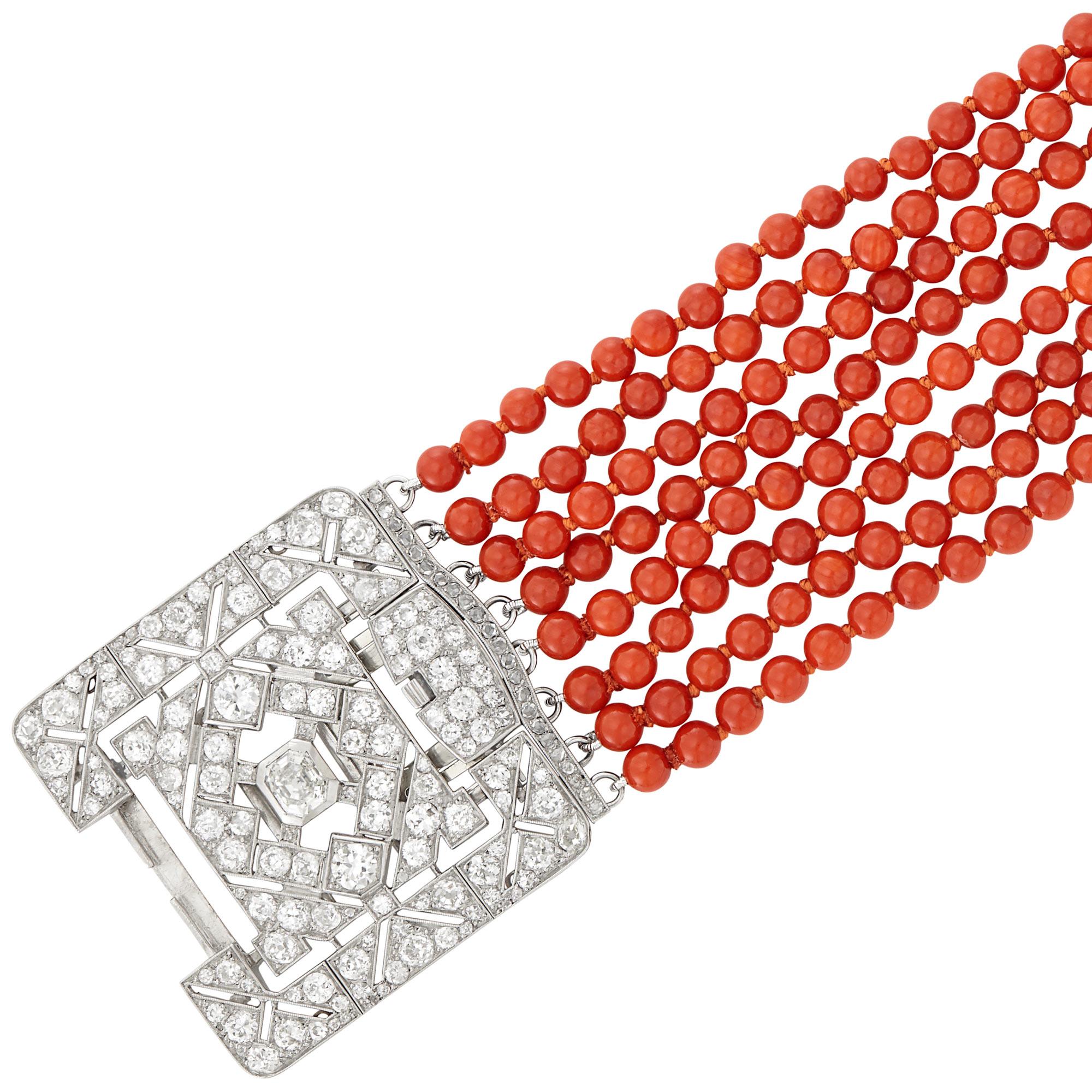 Eight Strand Coral Bead Bracelet with Platinum, White Gold and Diamond Clasp
Coral beads ap. 5.0 to 4.4 mm., one cut-cornered step emerald-cut diamond ap. .90 ct., 2 old European-cut diamonds ap. .80 ct., old European, old-mine & single-cut diamonds