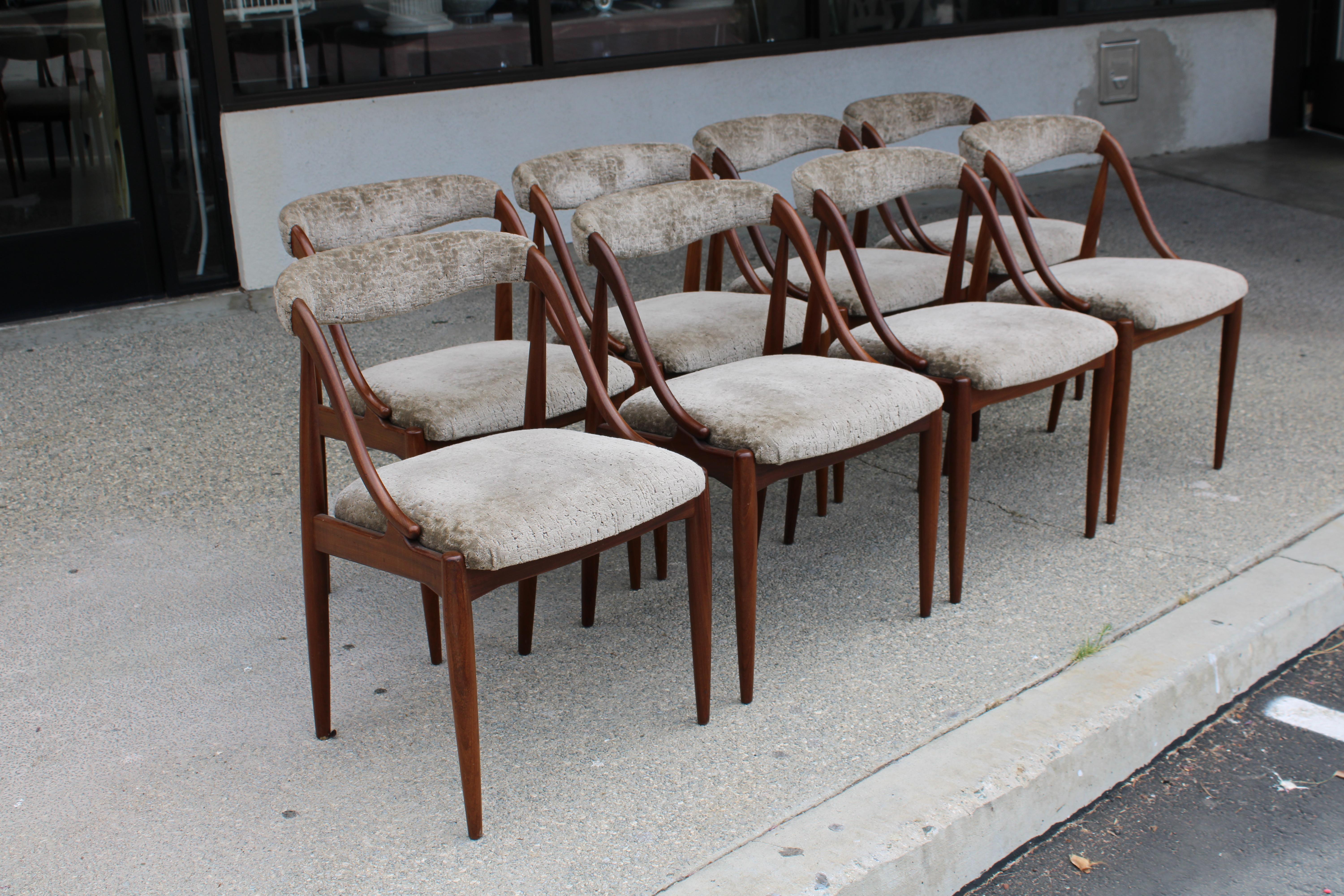 Eight teak dining chairs with custom upholstery by Johannes Andersen for Uldum Mobelfabrik. Each chair measures 19.5