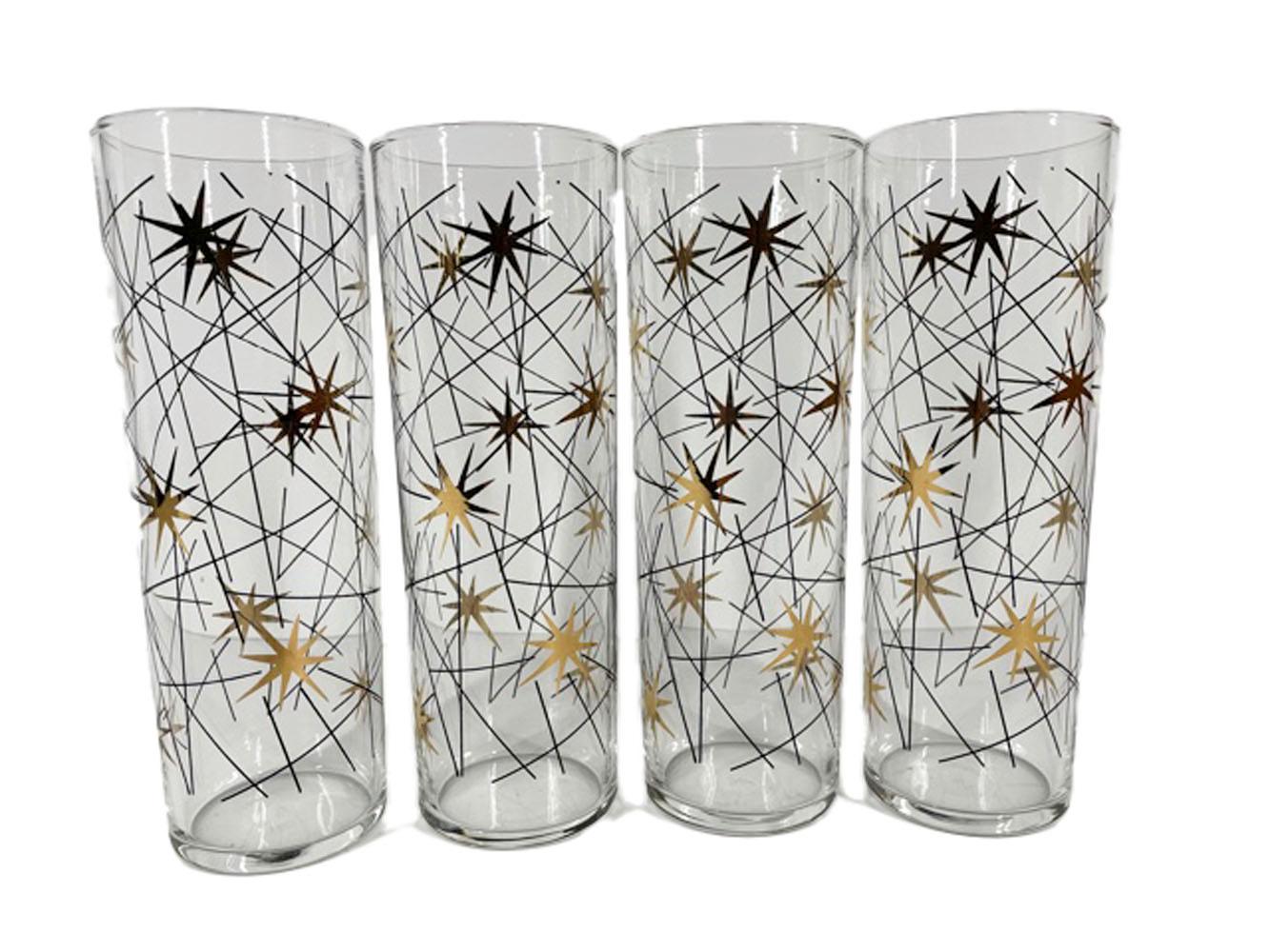 Set of 8 mid-twentieth century Tom Collins glasses in the atomic style with gold stars among scattered black enamel lines.