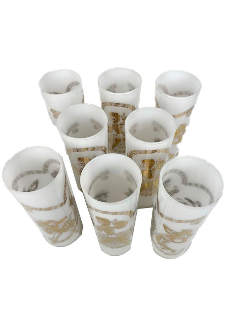 Eight mid-century Tom Collins glasses, clear glass with white frosted interiors and 22k gold Calypso performers on the exterior.